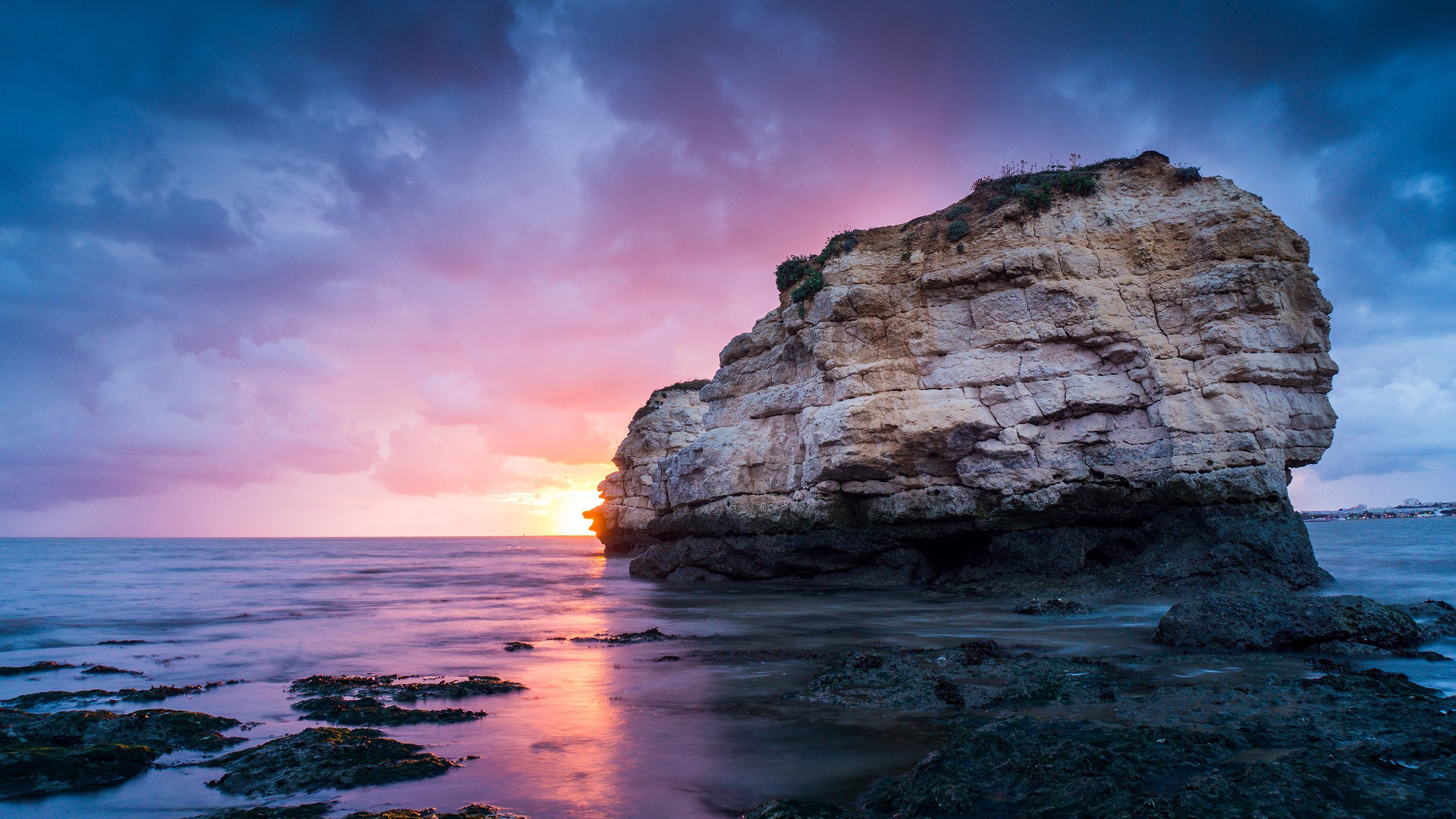 Coastal rock formation at sunset with ocean waves HD Wallpaper