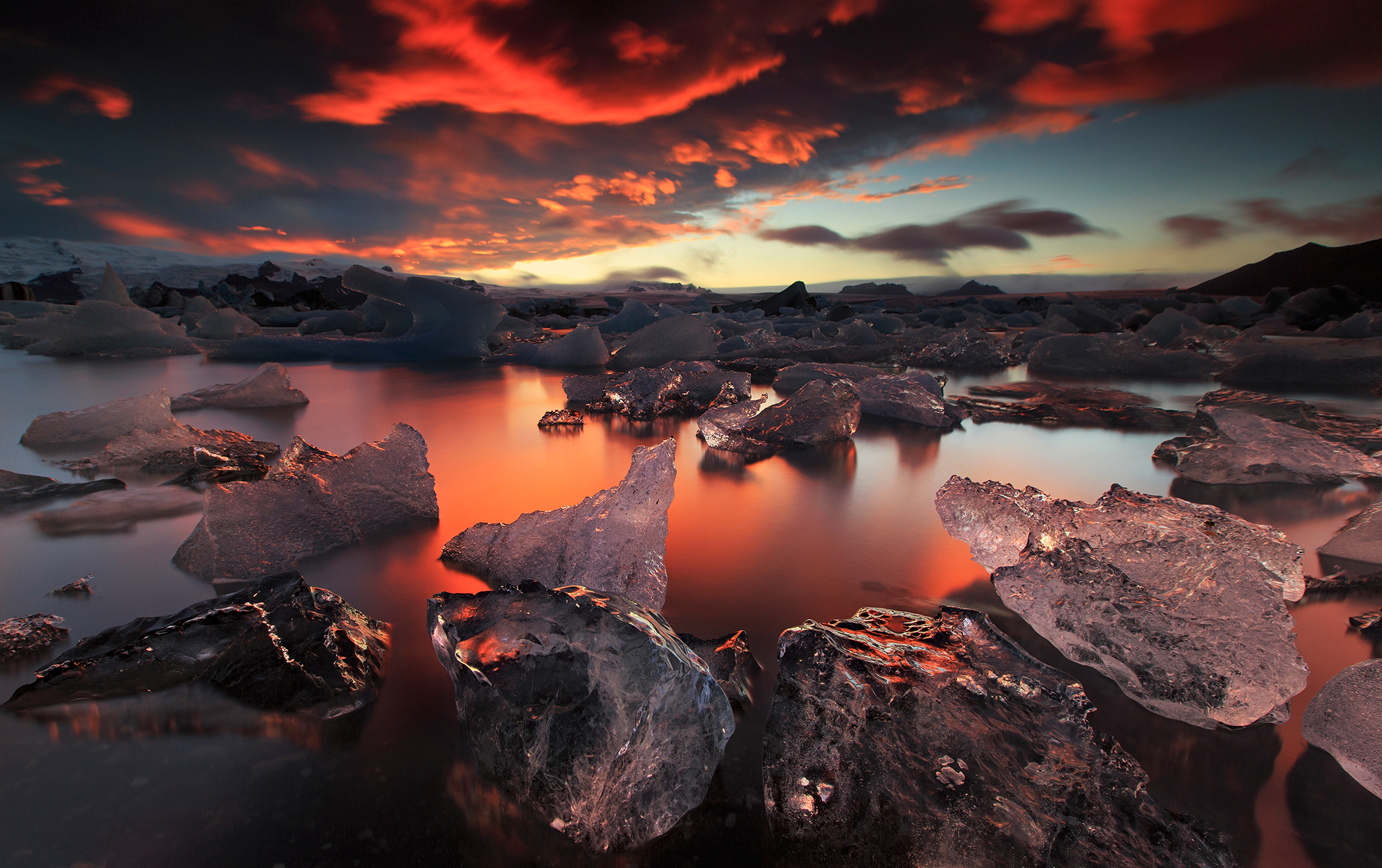 Icebergs floating in a lake during sunset HD Wallpaper