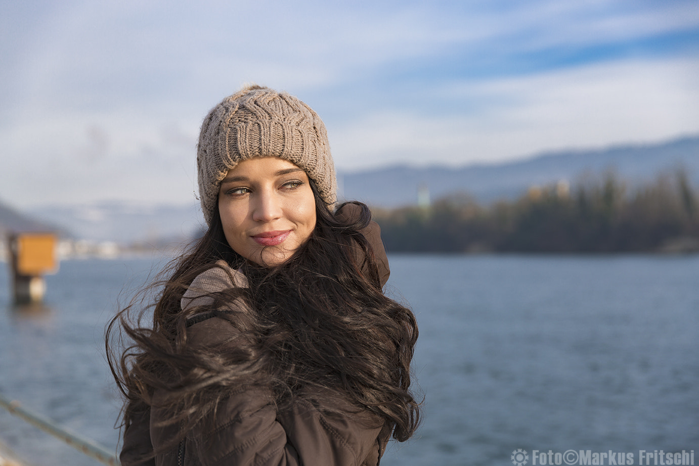 Woman in hat and jacket by the water HD Wallpaper