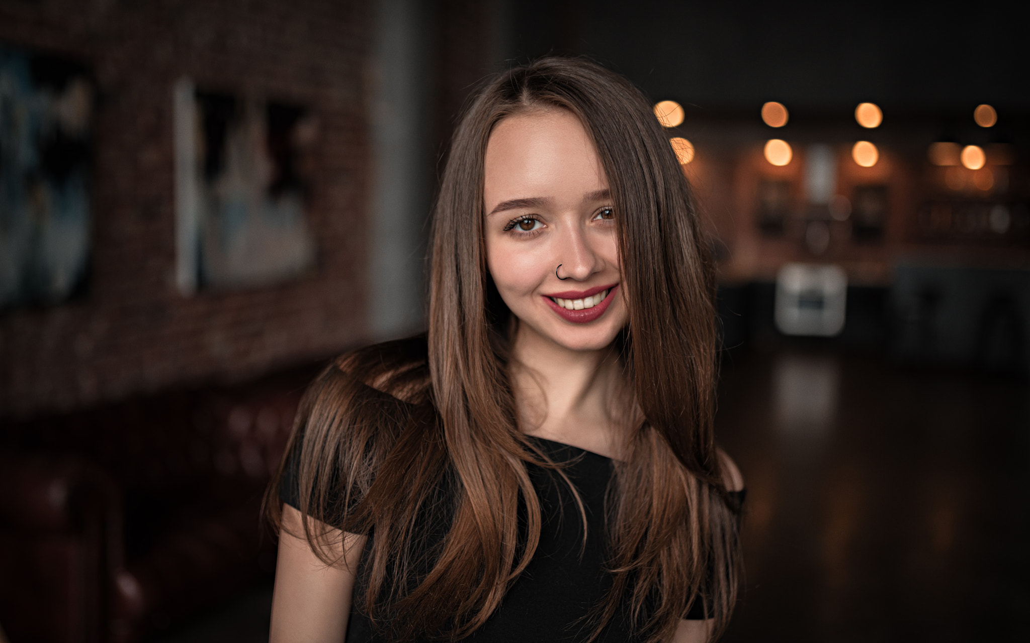 Woman with long brown hair and nose ring smiling HD Wallpaper
