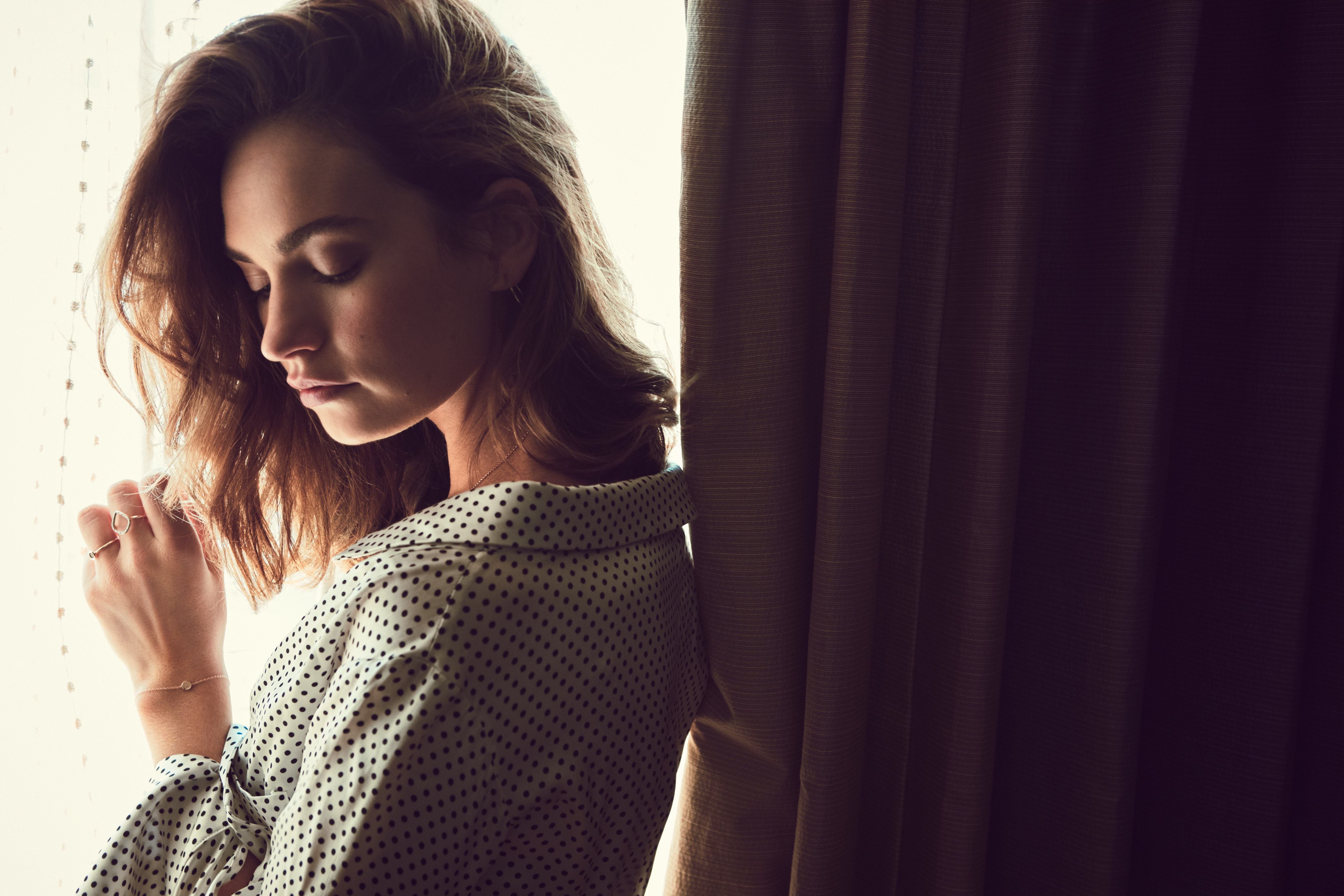 Lily James posing by a window HD Wallpaper