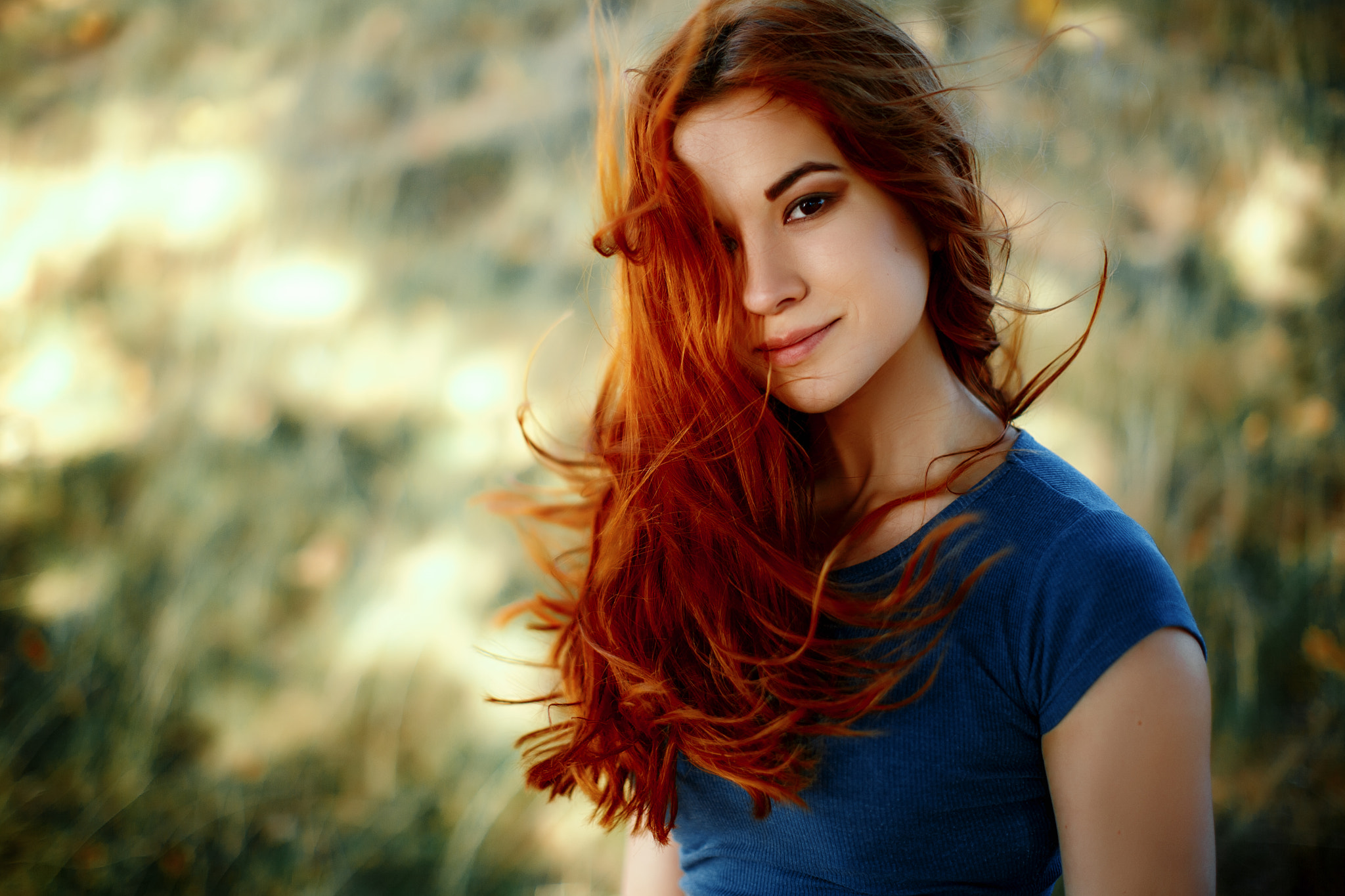 Redhead woman with windblown hair in a blue shirt HD Wallpaper
