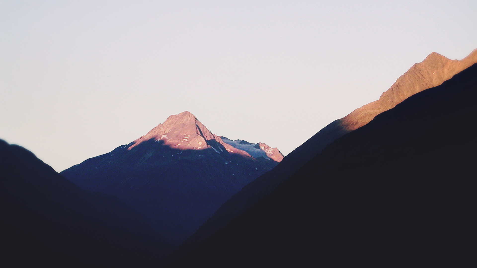 Mountain peaks at sunrise with shadows HD Wallpaper