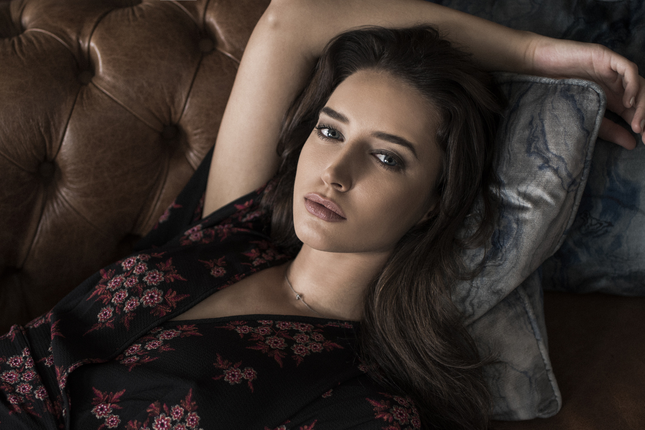 Woman lying on a leather couch HD Wallpaper