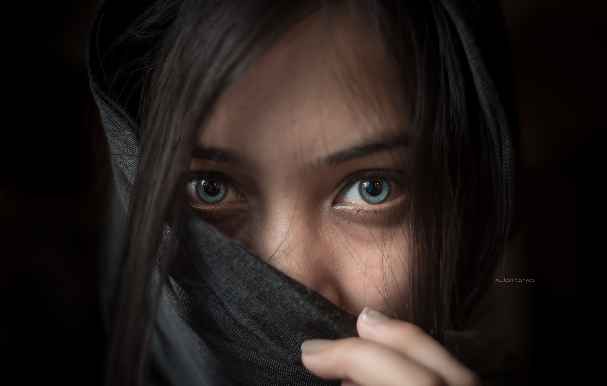 Woman with blue eyes wearing a dark headscarf HD Wallpaper