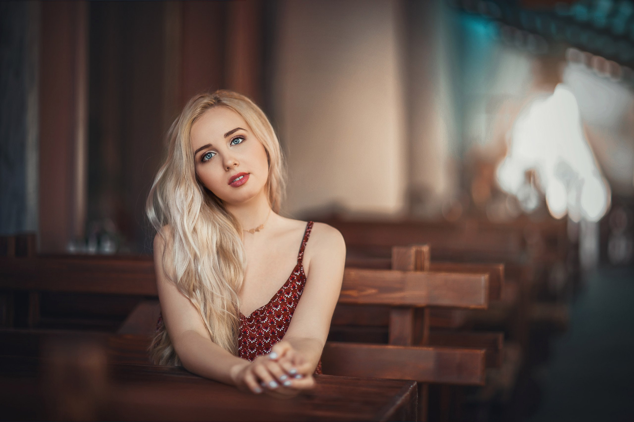 Woman with blonde hair and blue eyes sitting HD Wallpaper