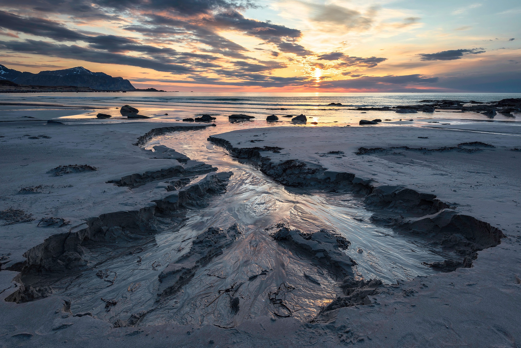 Beach stream at sunset with mountains HD Wallpaper