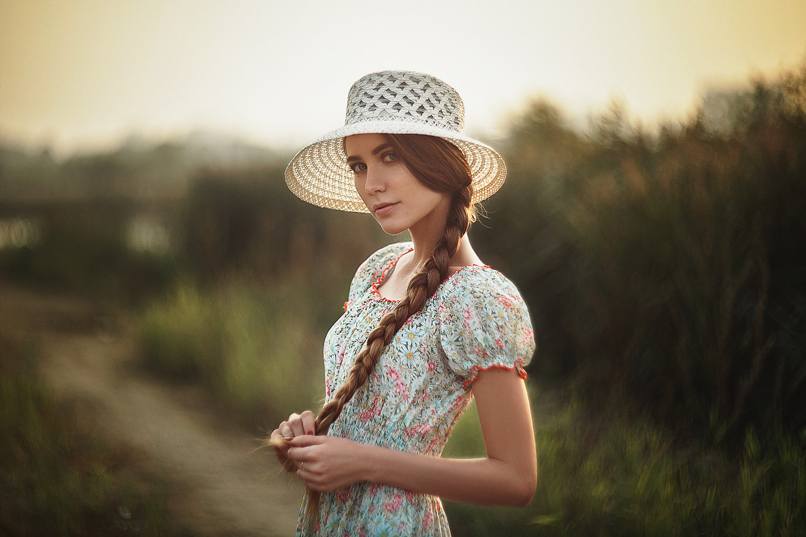 Woman in a straw hat and floral dress outdoors HD Wallpaper
