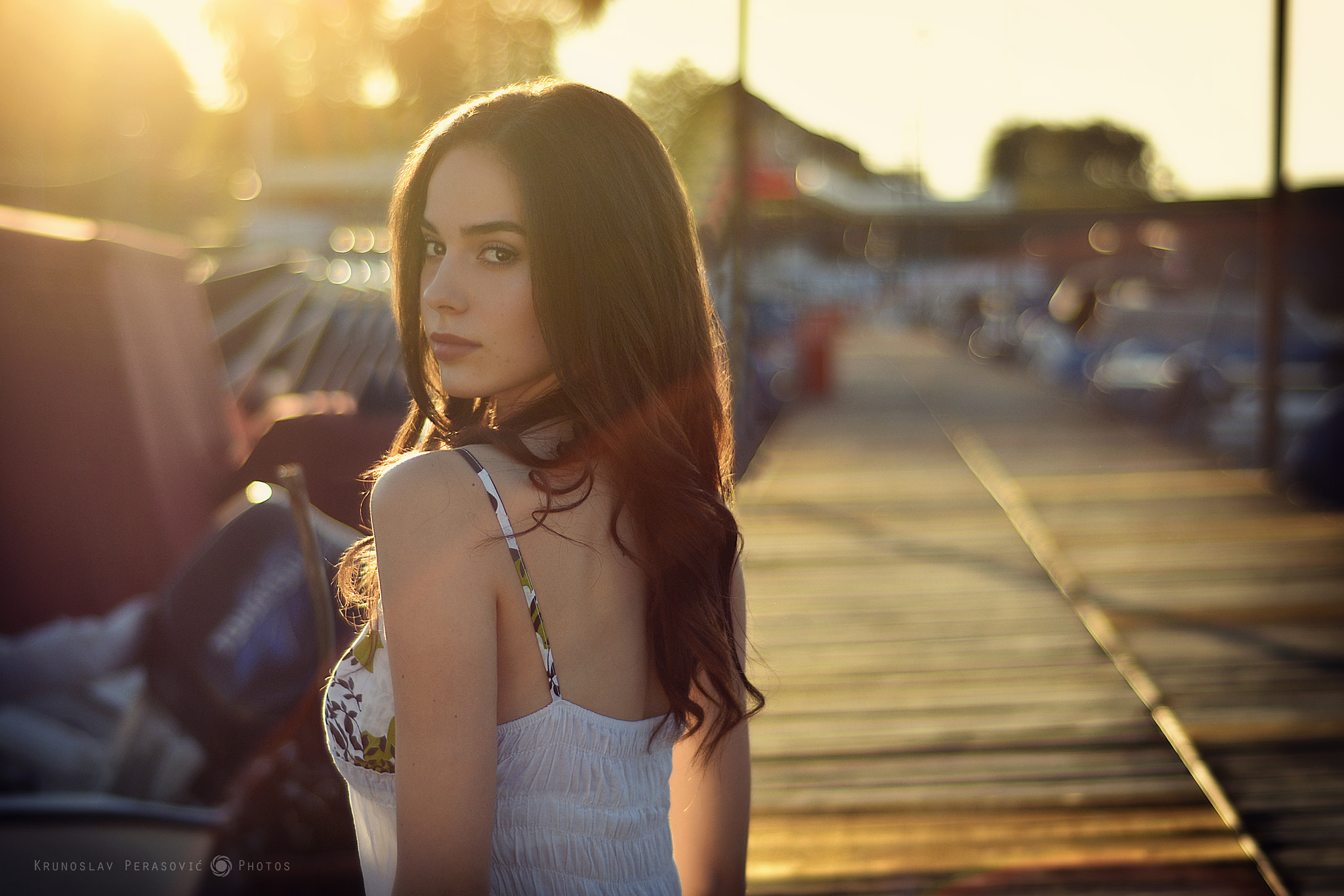 Woman looking over shoulder at sunset HD Wallpaper