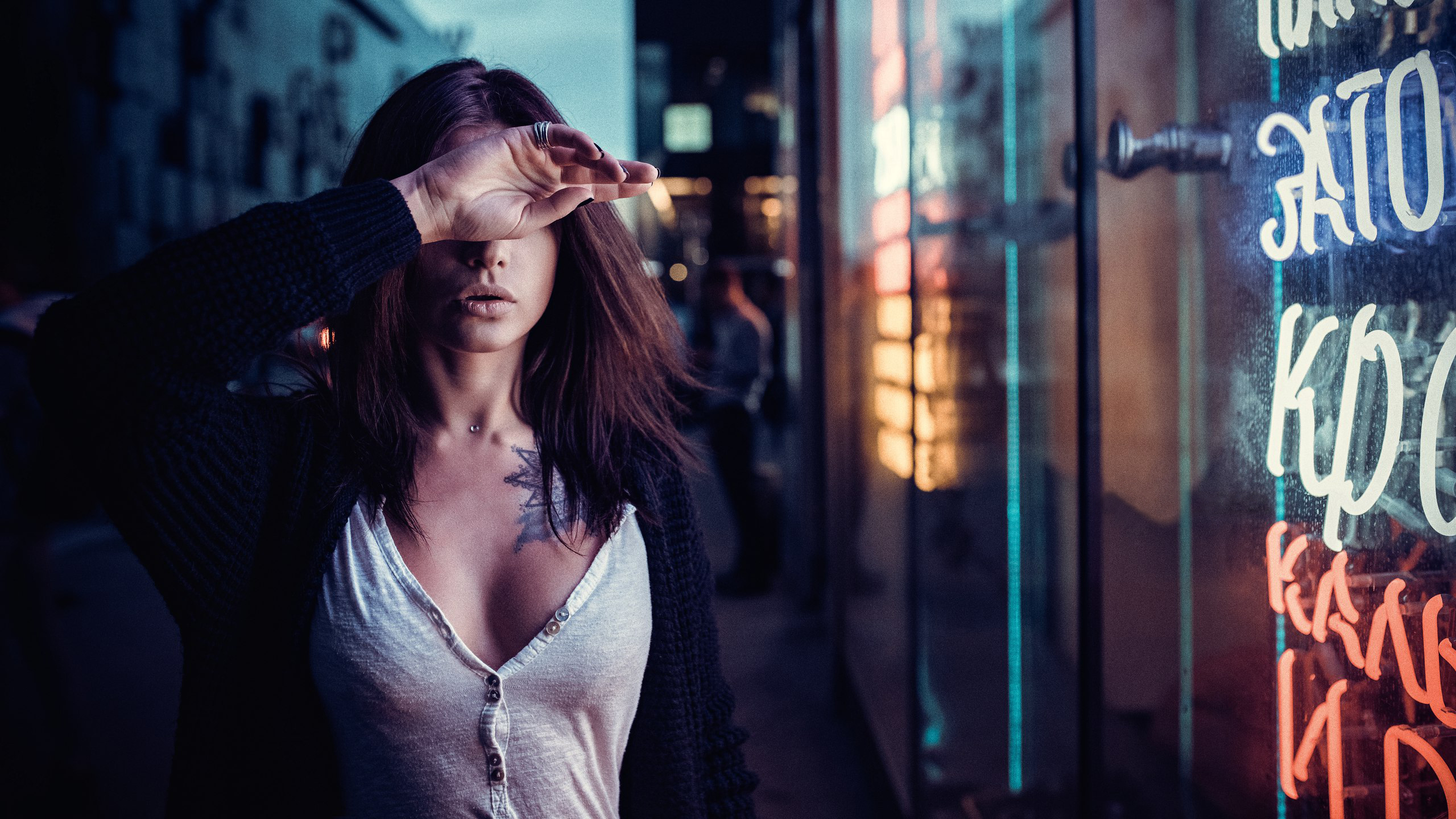 Woman with hand over face near neon sign HD Wallpaper