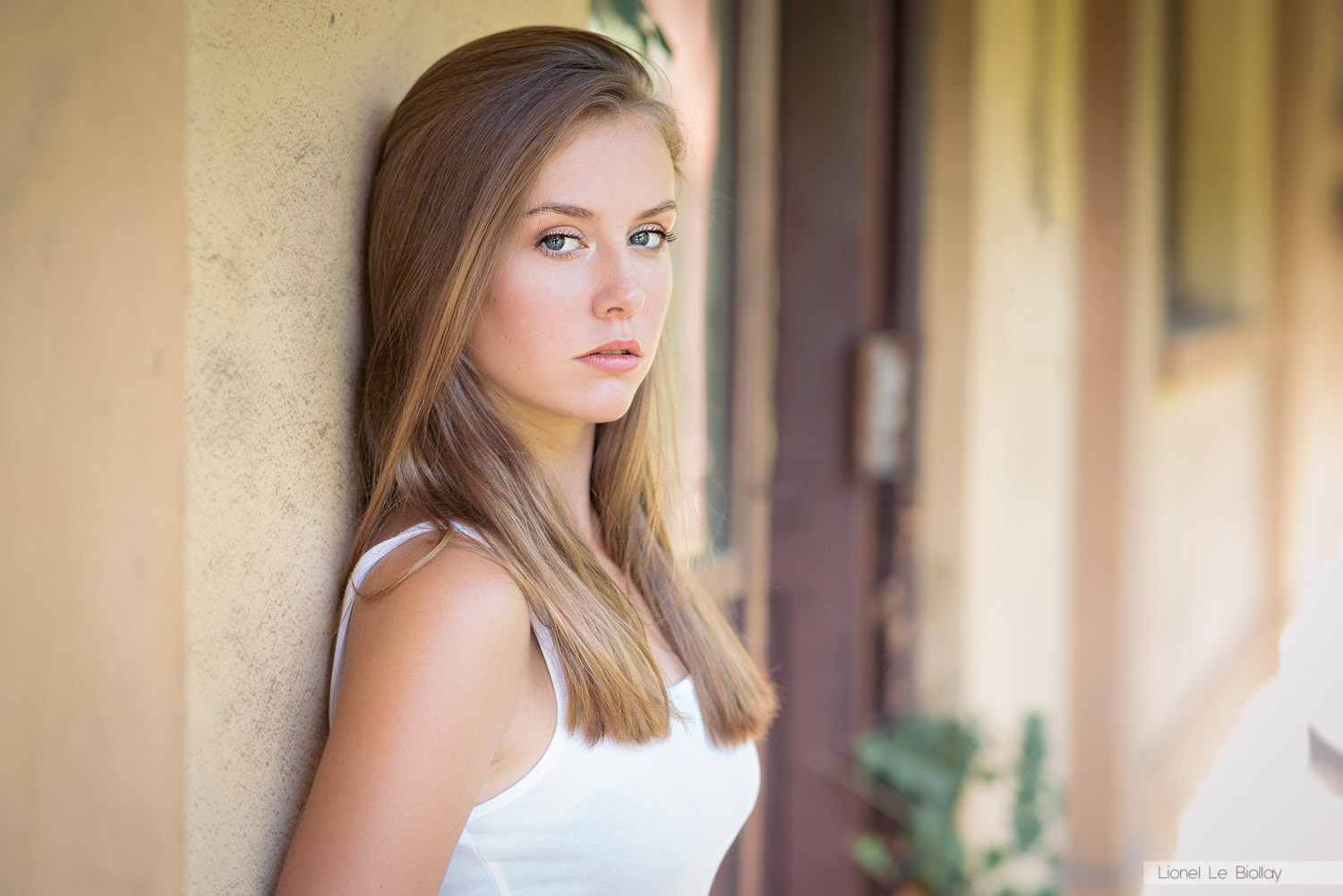 Woman in white tank top leaning against wall HD Wallpaper