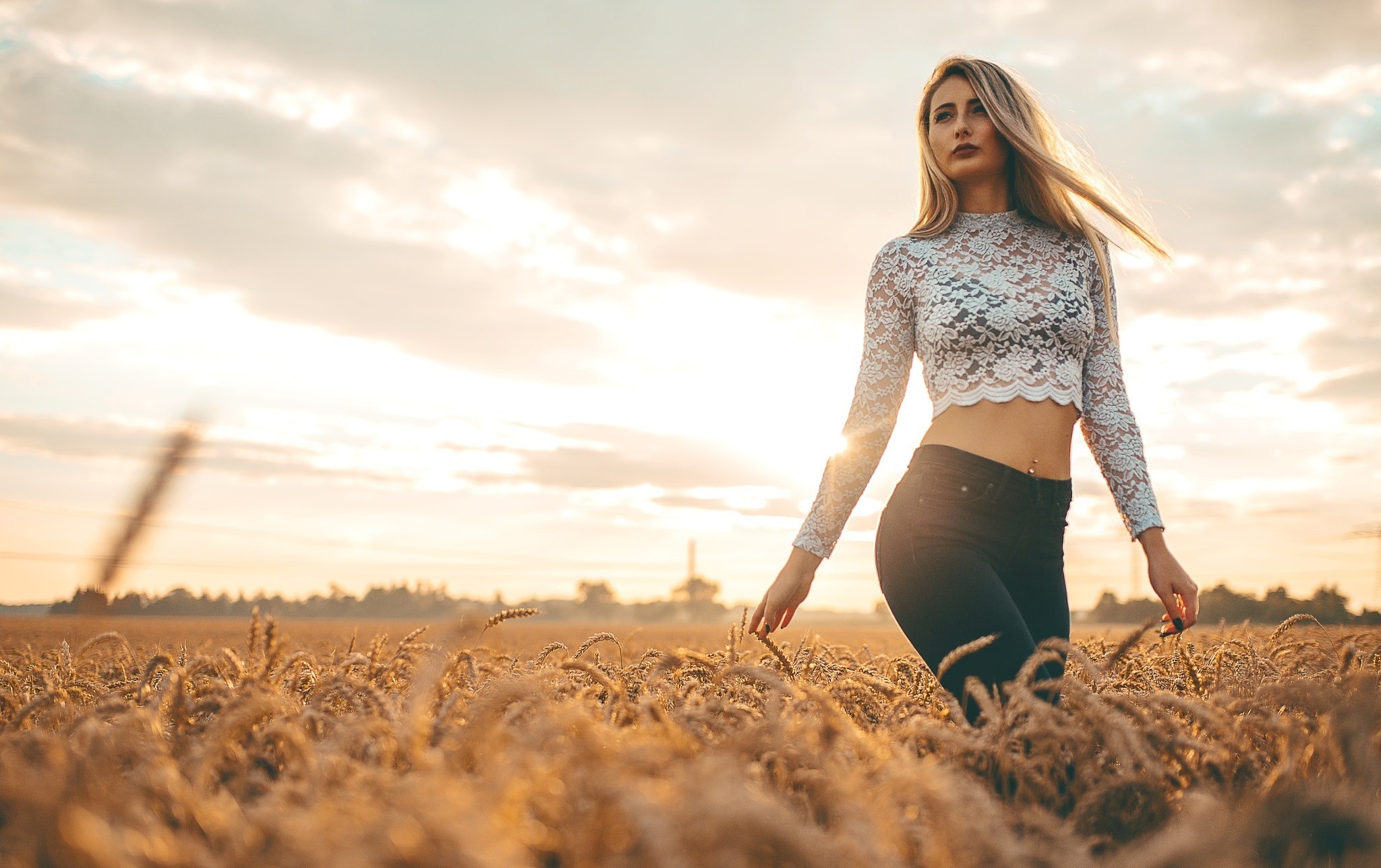 Woman in lace top walking through a wheat field at sunset HD Wallpaper