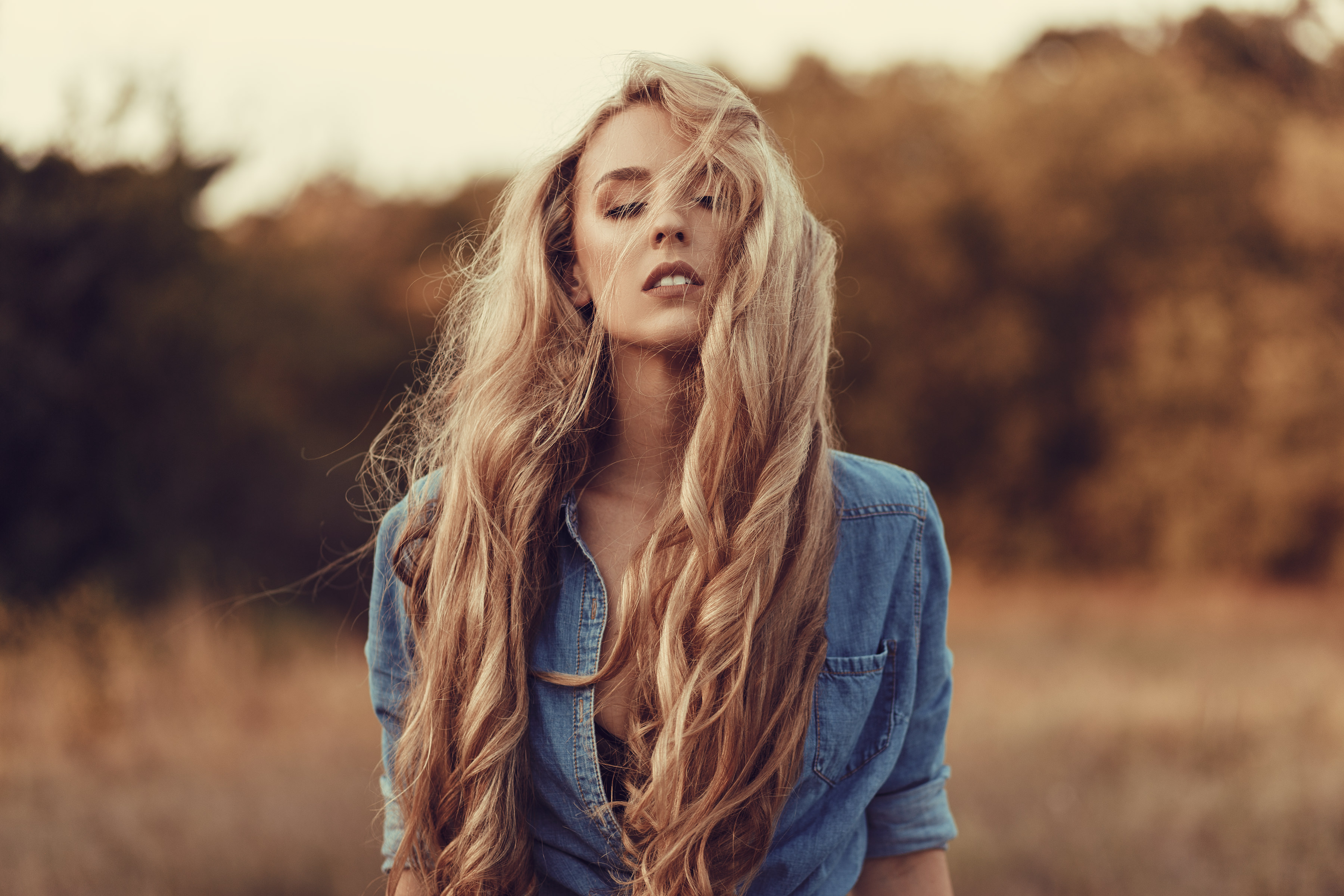 Woman with long blonde hair in a denim shirt outdoors HD Wallpaper