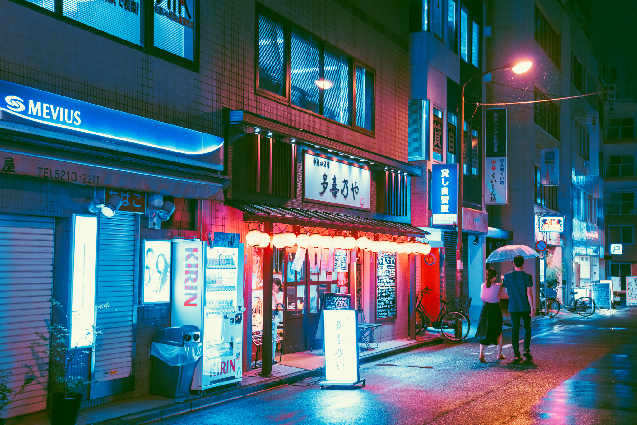 Japanese street with Mevius and Kirin signs at night HD Wallpaper