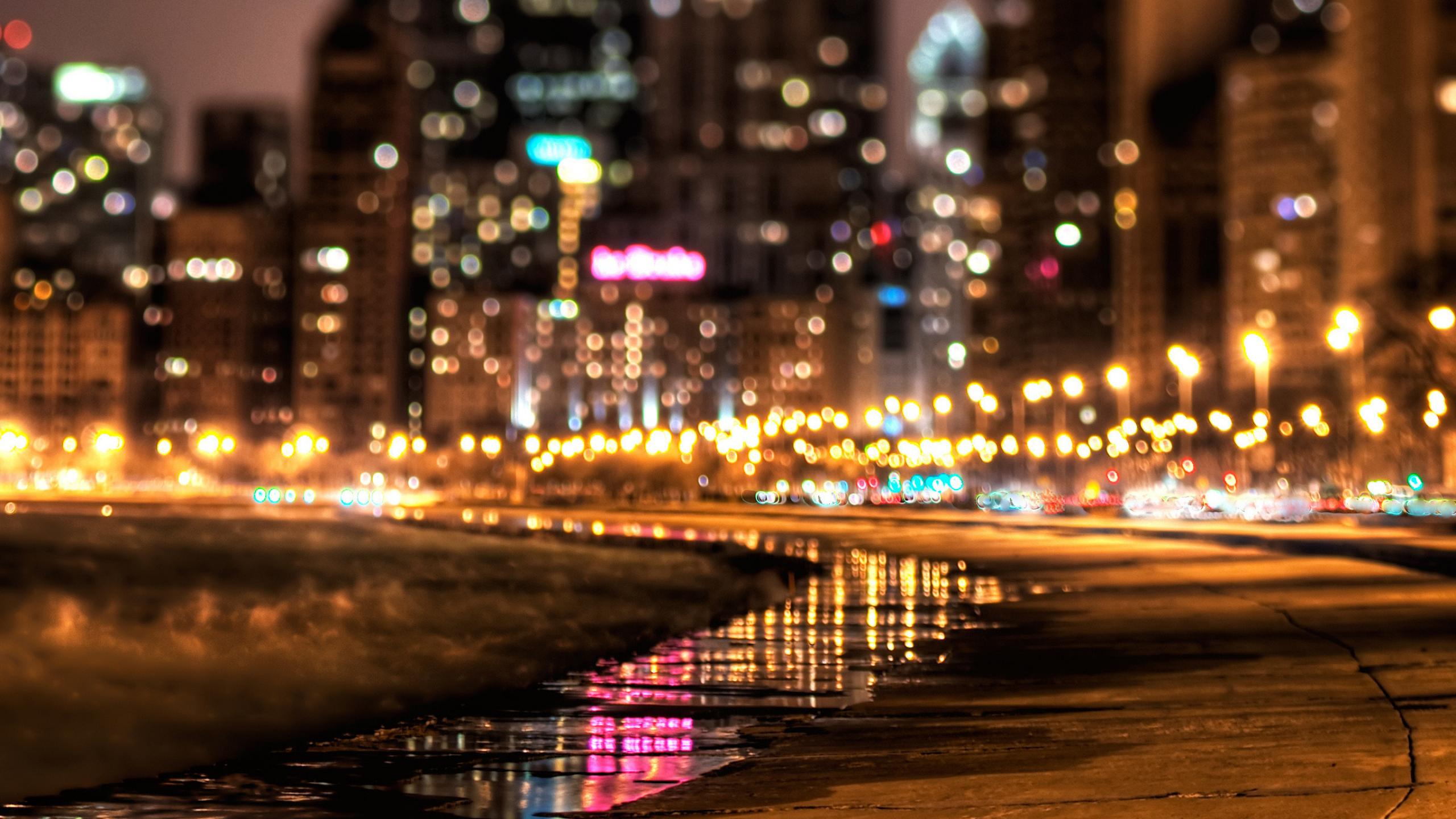Cityscape at night with bokeh lights and reflections HD Wallpaper