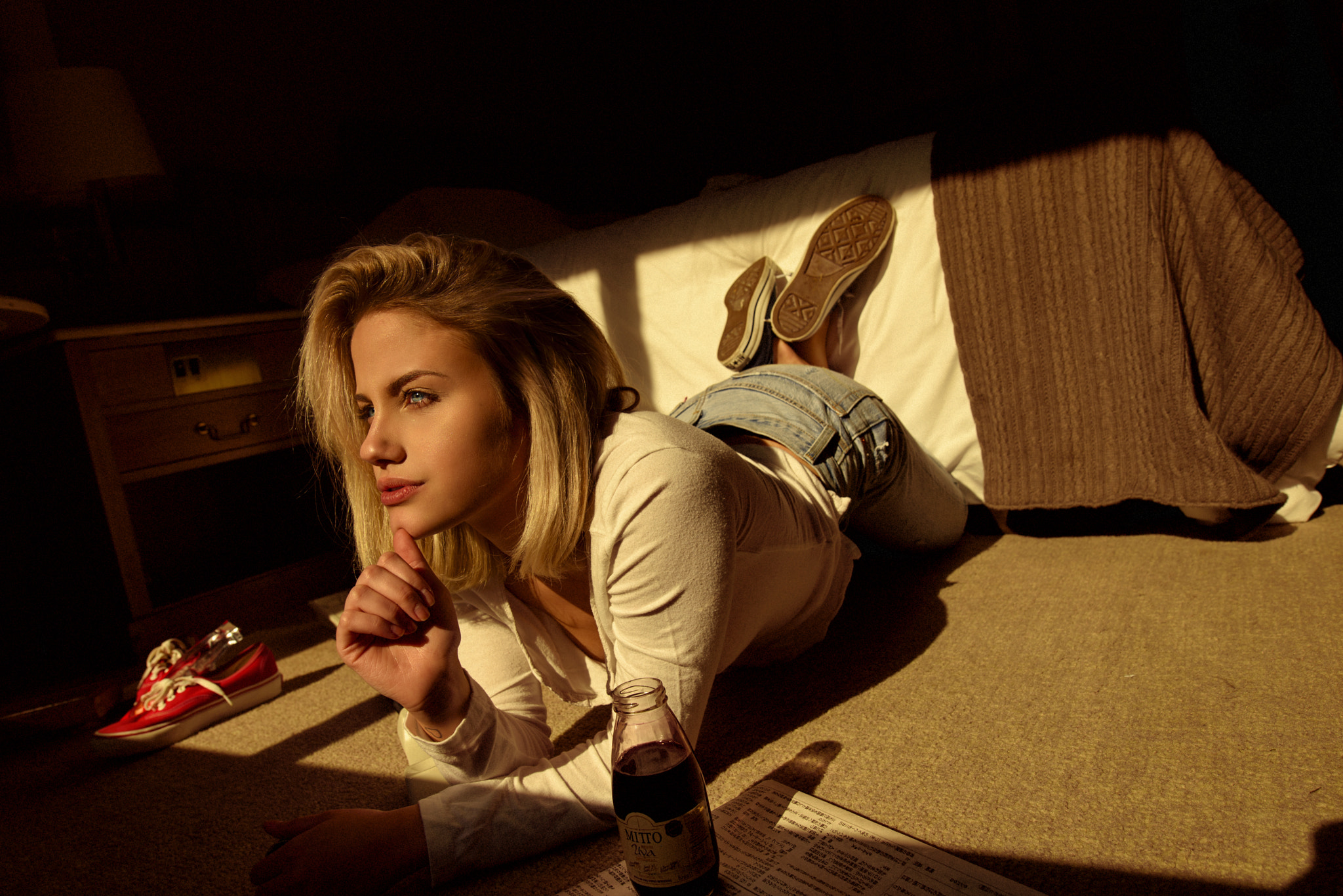 Woman in jeans and shirt lying on floor HD Wallpaper