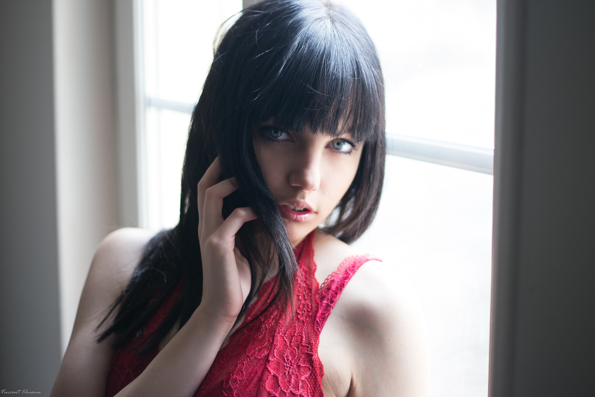 Woman with dark hair and blue eyes wearing red lace HD Wallpaper