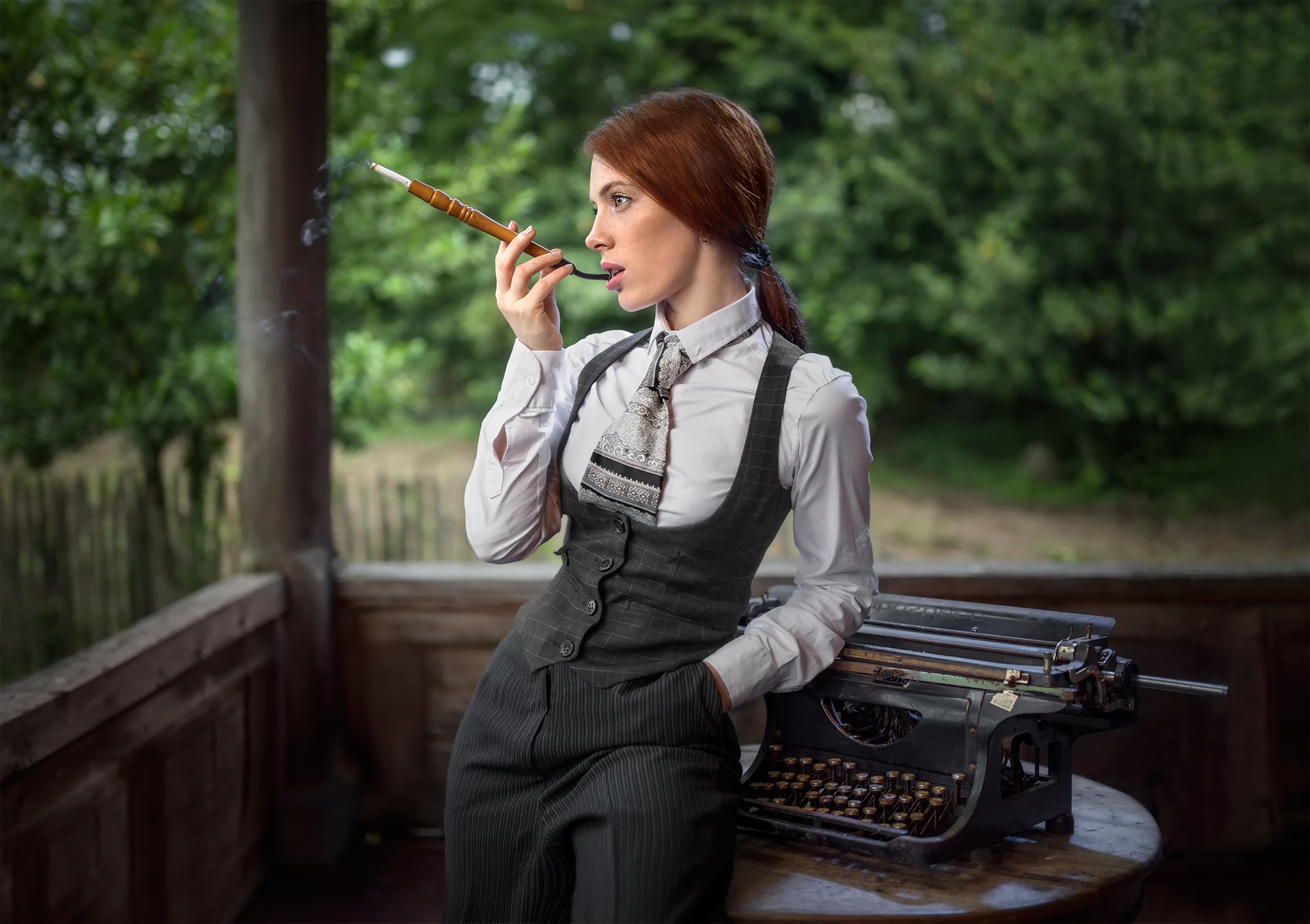 Woman with cigarette holder and typewriter HD Wallpaper