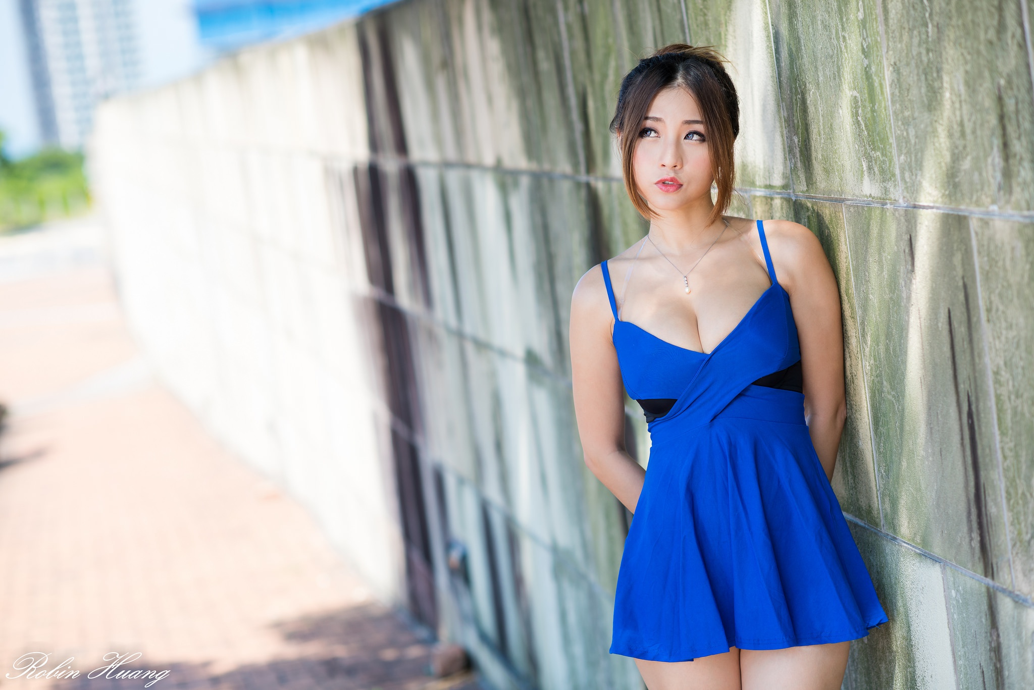Asian woman in blue dress leaning against a wall HD Wallpaper