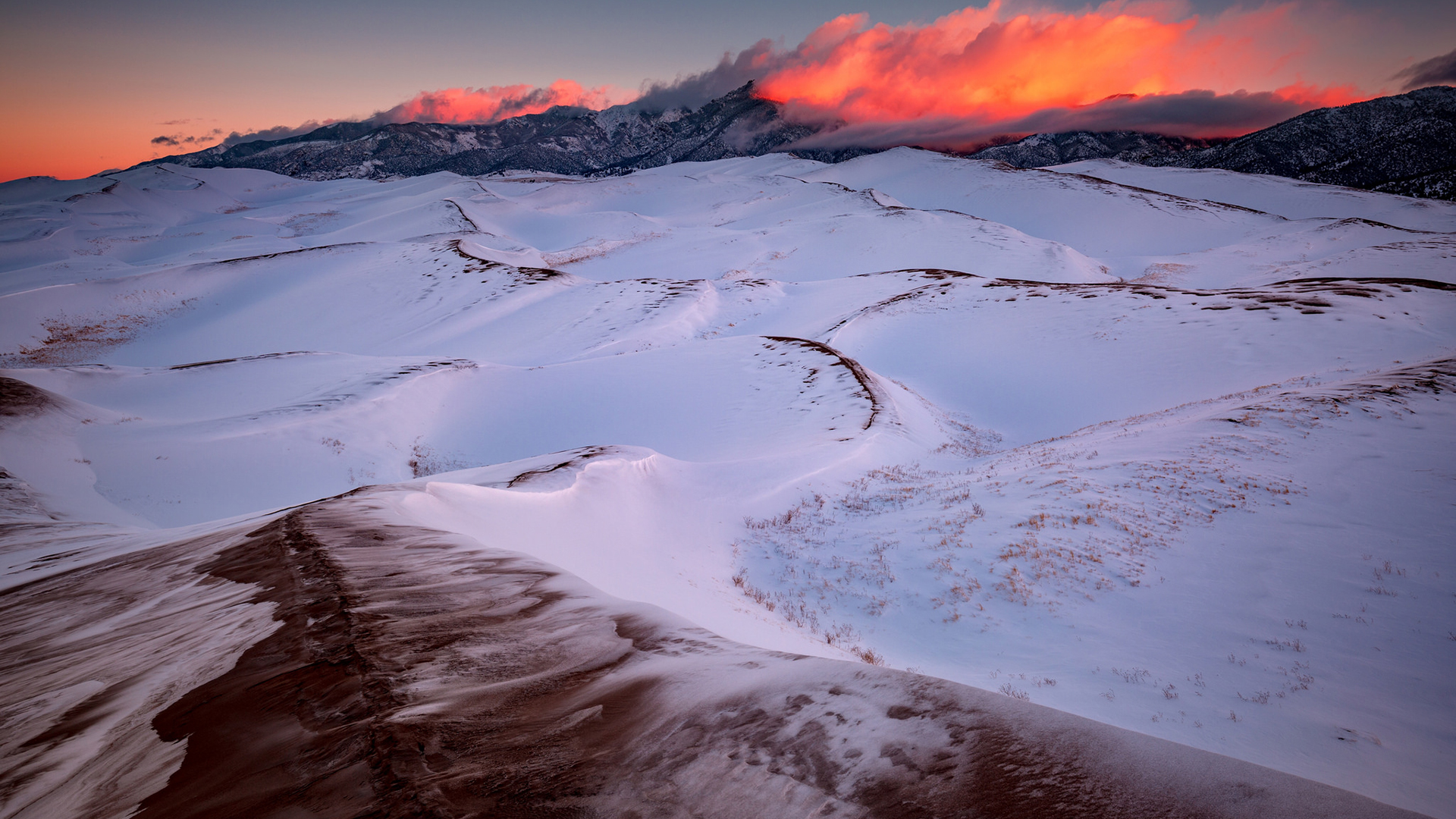 Sunset over snow-covered dunes in Great Sand Dunes National Park HD Wallpaper