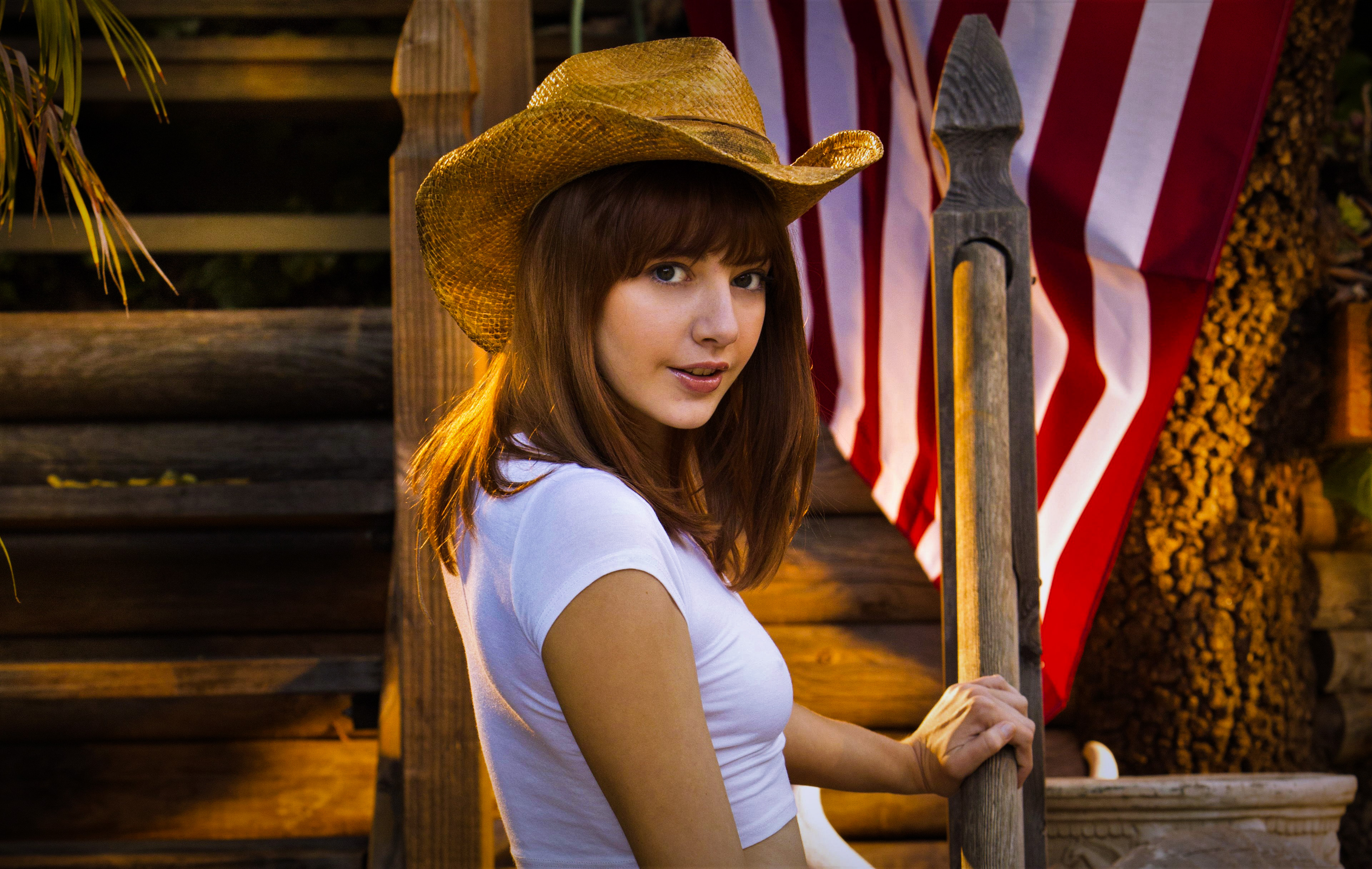 Woman in cowboy hat and white top with American flag HD Wallpaper
