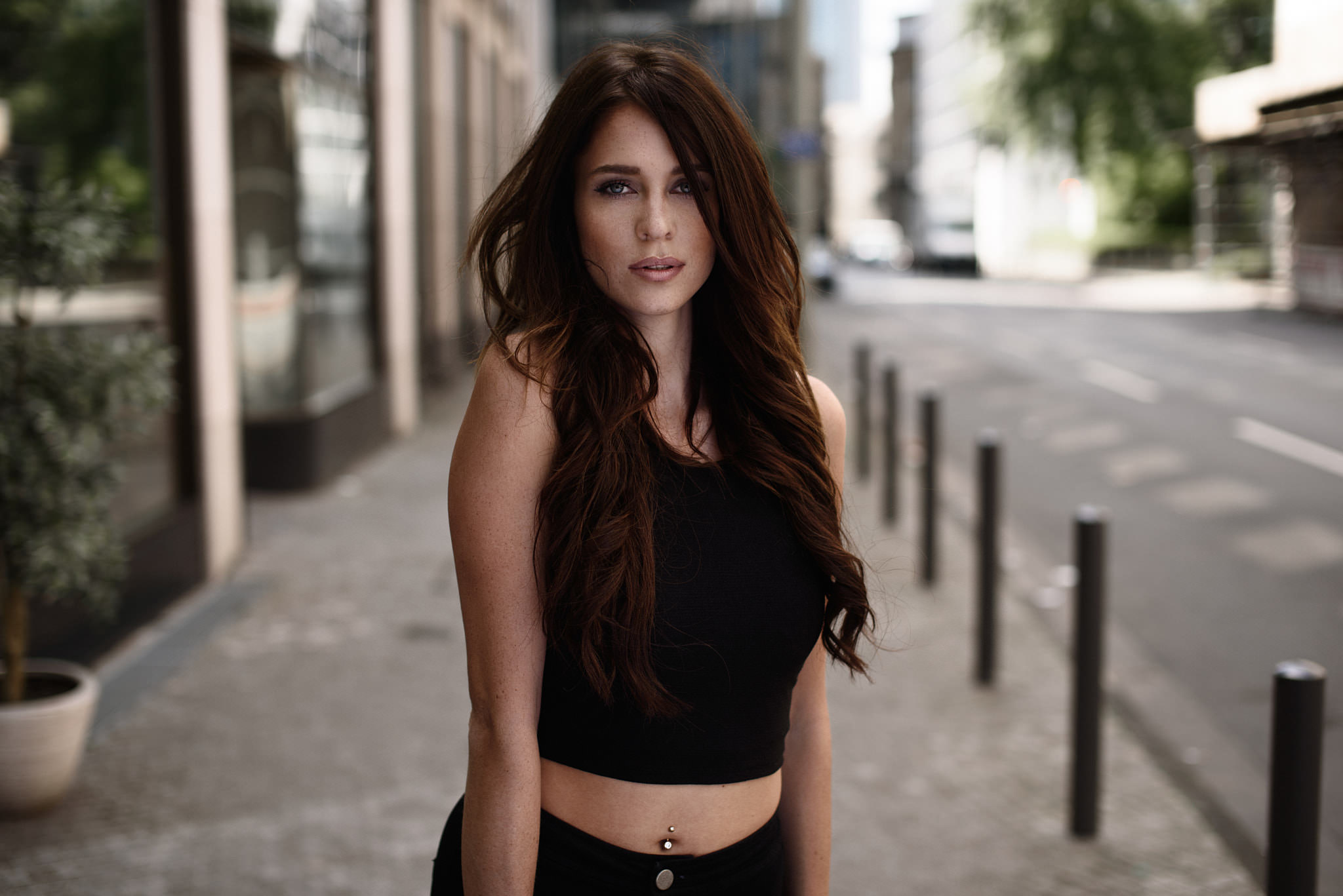 Woman with pierced navel standing on a street HD Wallpaper