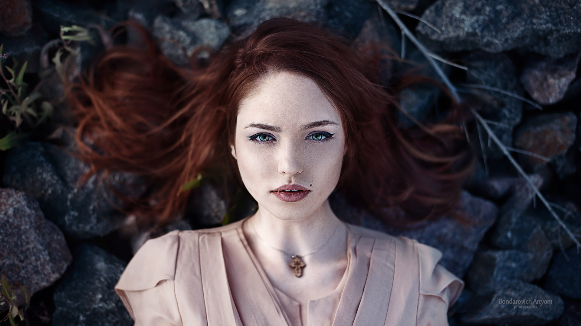 Woman with red hair lying on rocks HD Wallpaper