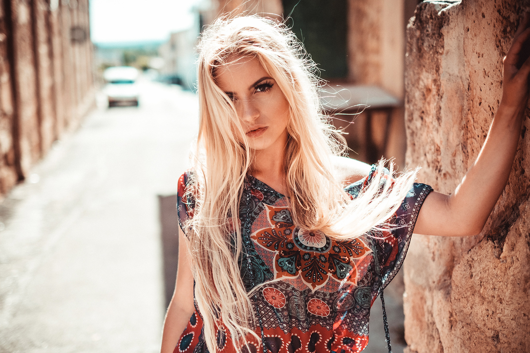 Woman with blonde hair in a patterned dress outdoors HD Wallpaper