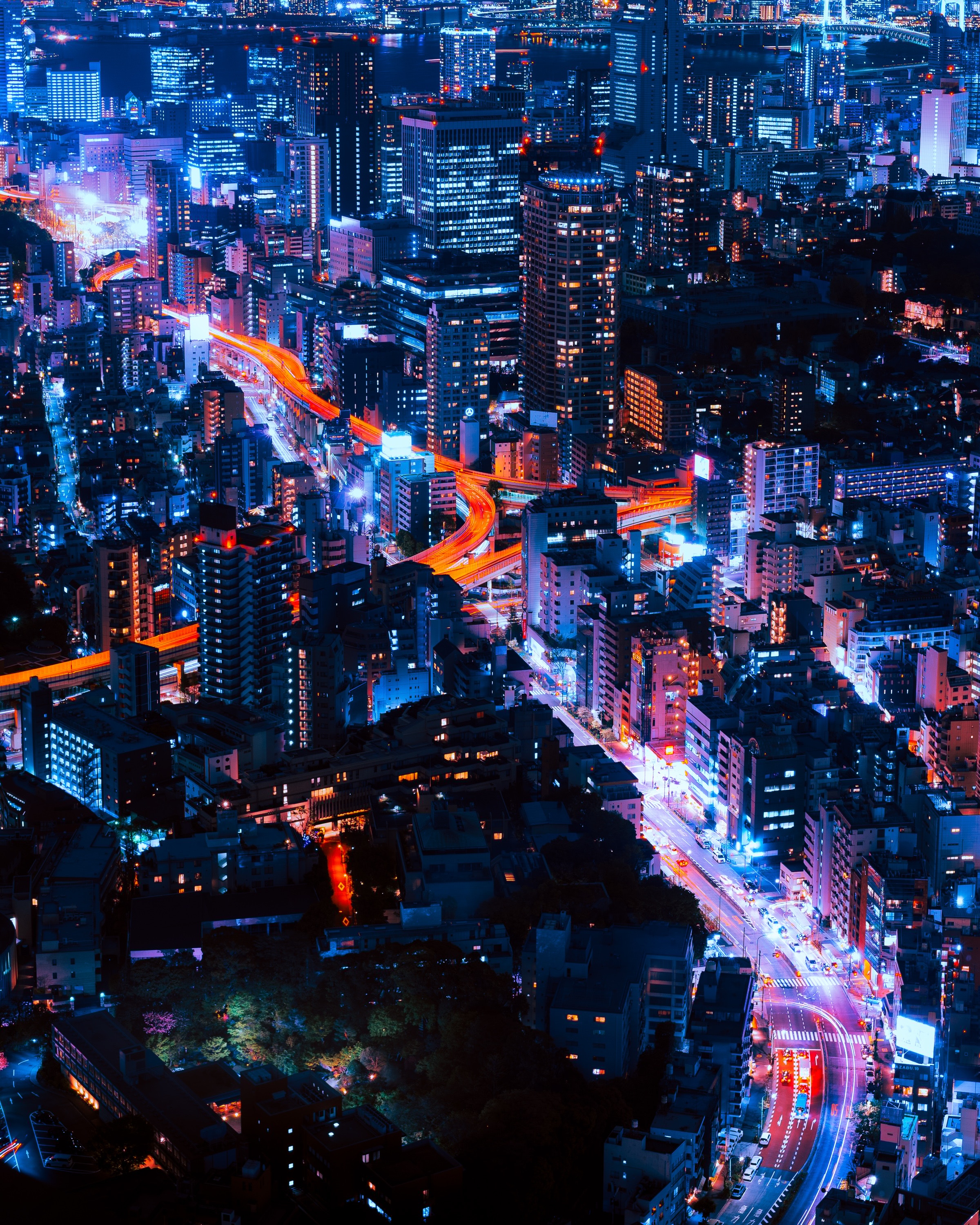 Aerial view of Tokyo at night with illuminated highways HD Wallpaper