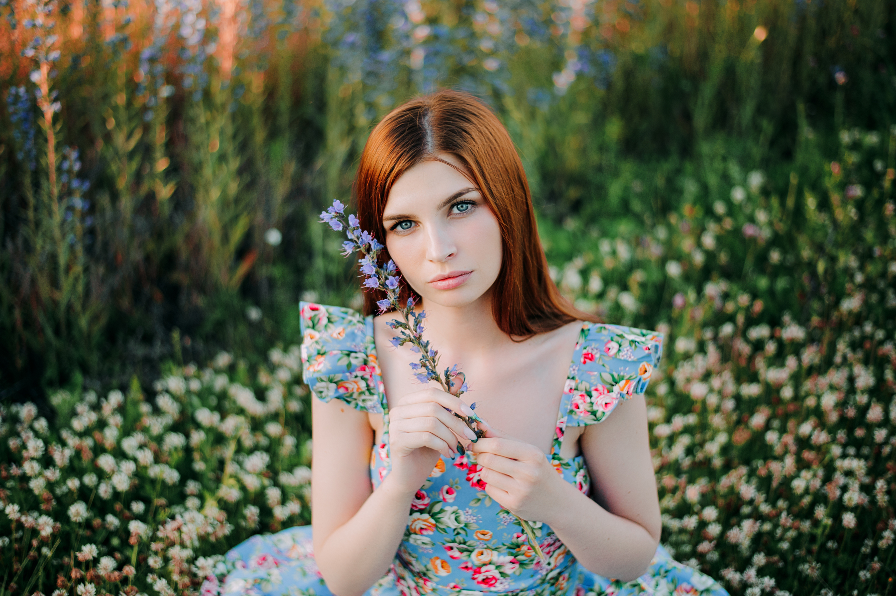 Woman with red hair and blue eyes holding a flower HD Wallpaper