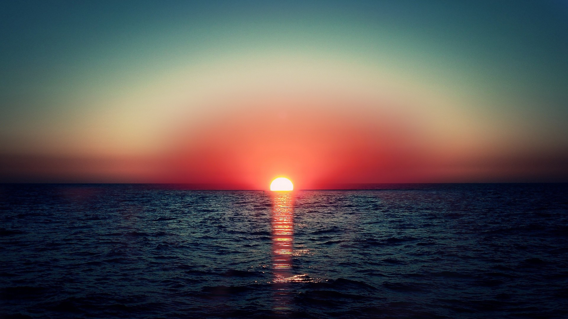 Sunset over the ocean with sun rays HD Wallpaper