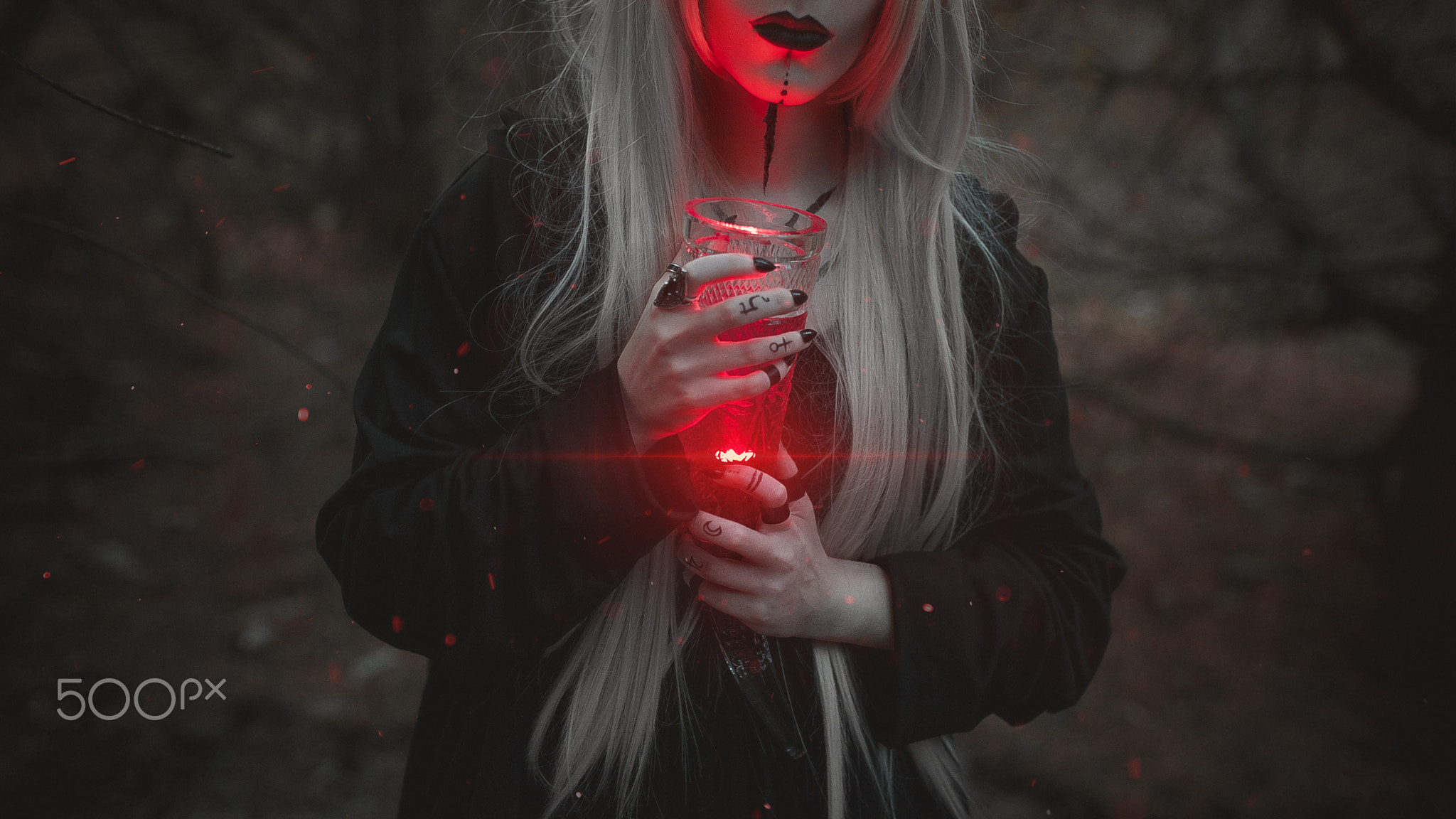 Woman with long blonde hair holding a glowing red glass HD Wallpaper