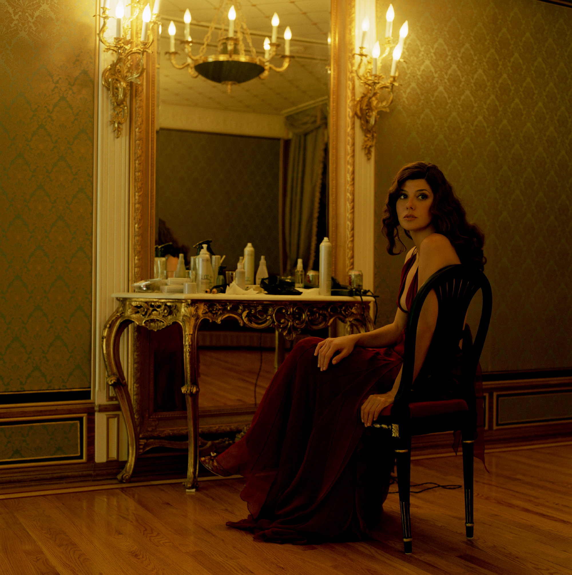 Marisa Tomei in a red dress sitting in a room HD Wallpaper