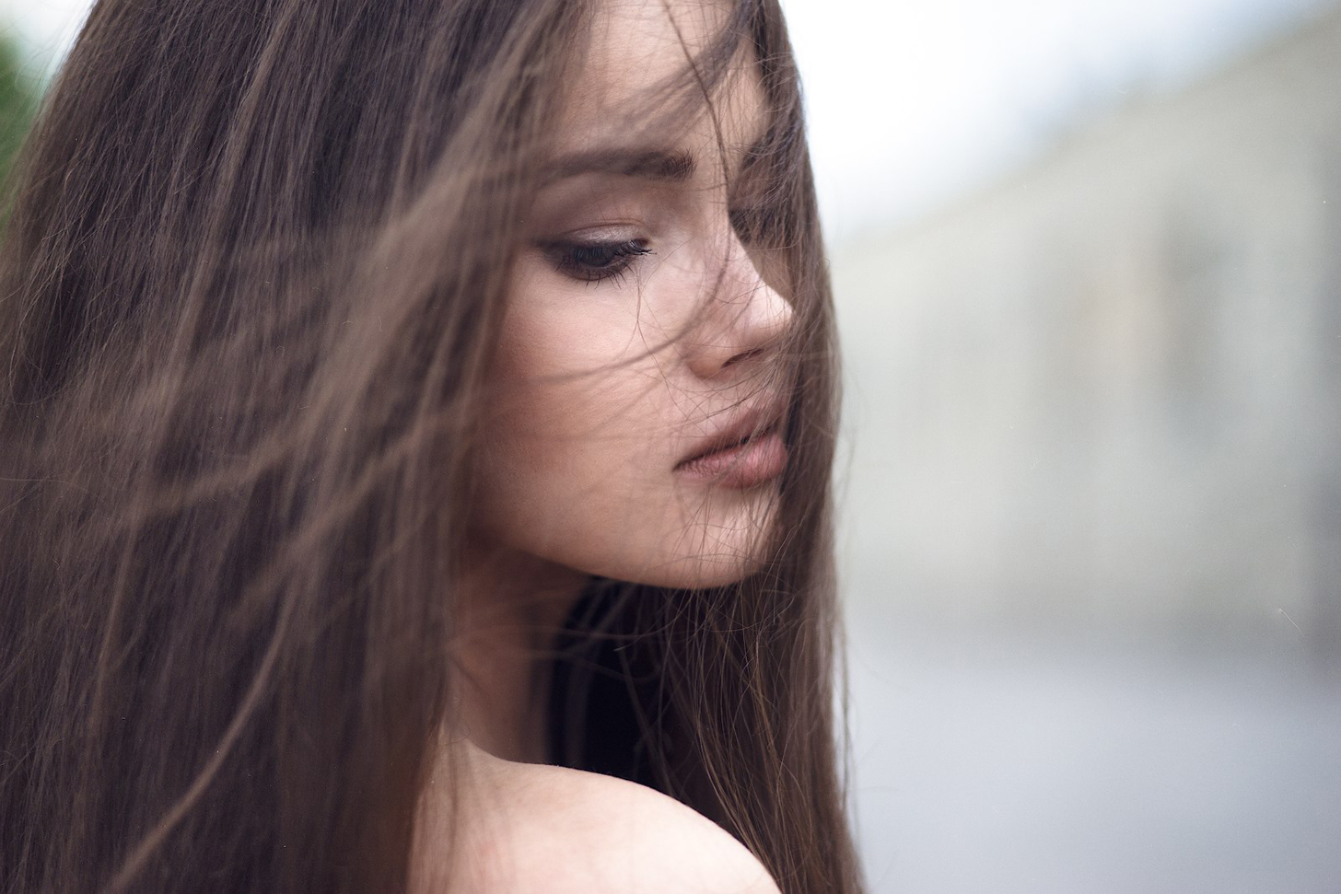 Woman with long brown hair in profile HD Wallpaper