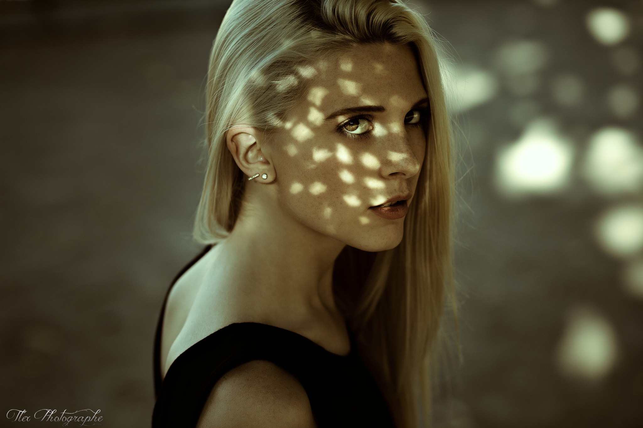 Portrait of a blonde woman with dappled light on her face HD Wallpaper