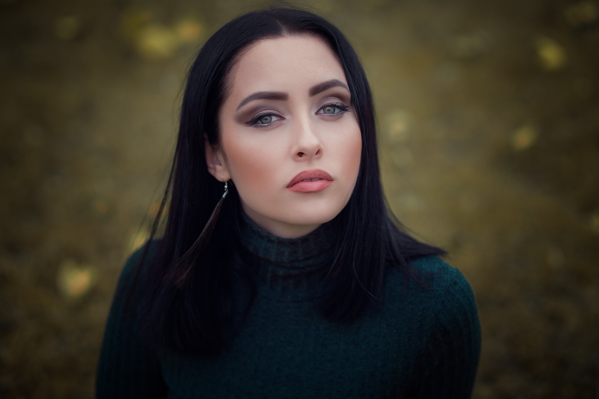Portrait of a woman with dark hair and makeup HD Wallpaper