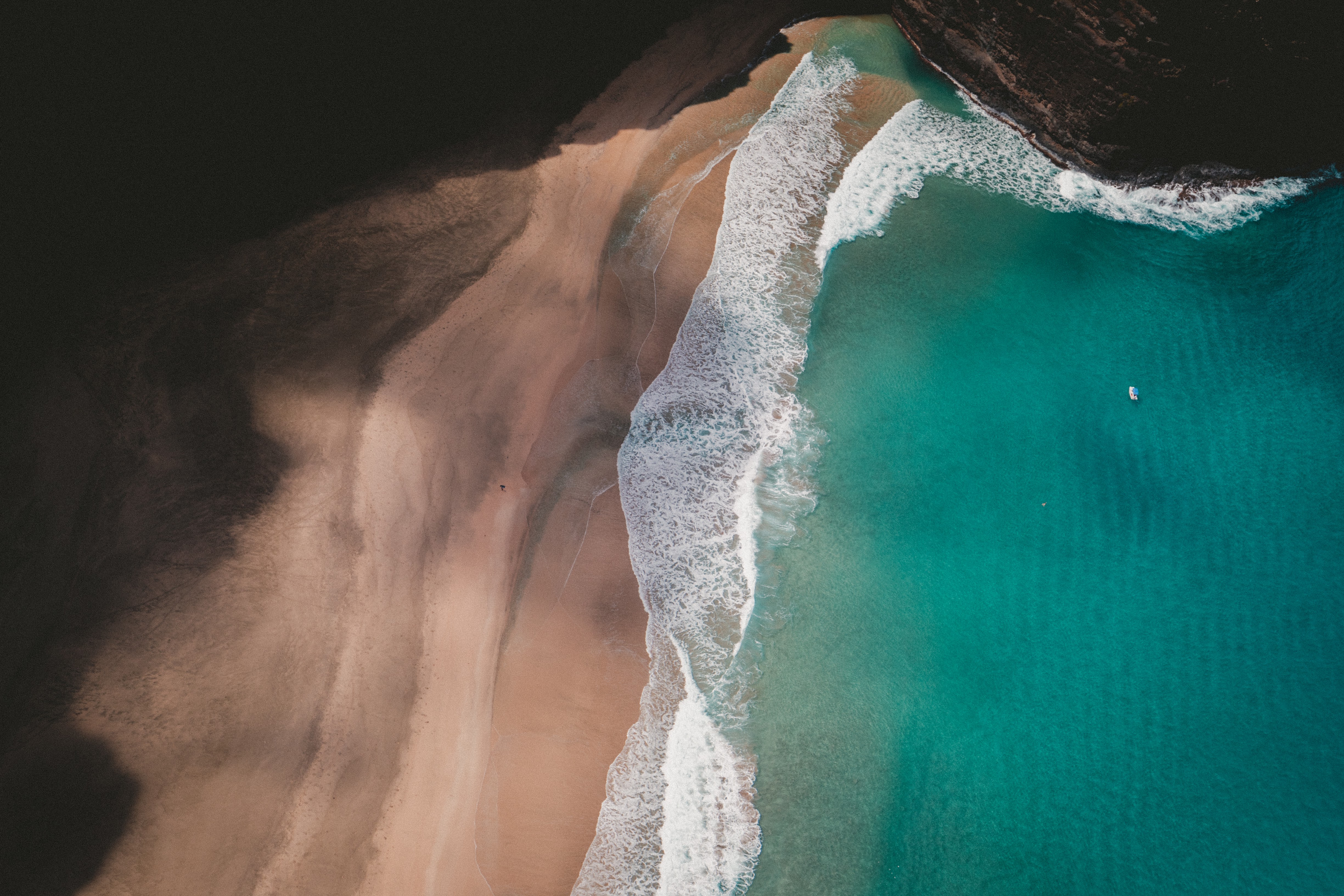 Aerial view of a beach with turquoise water and waves HD Wallpaper