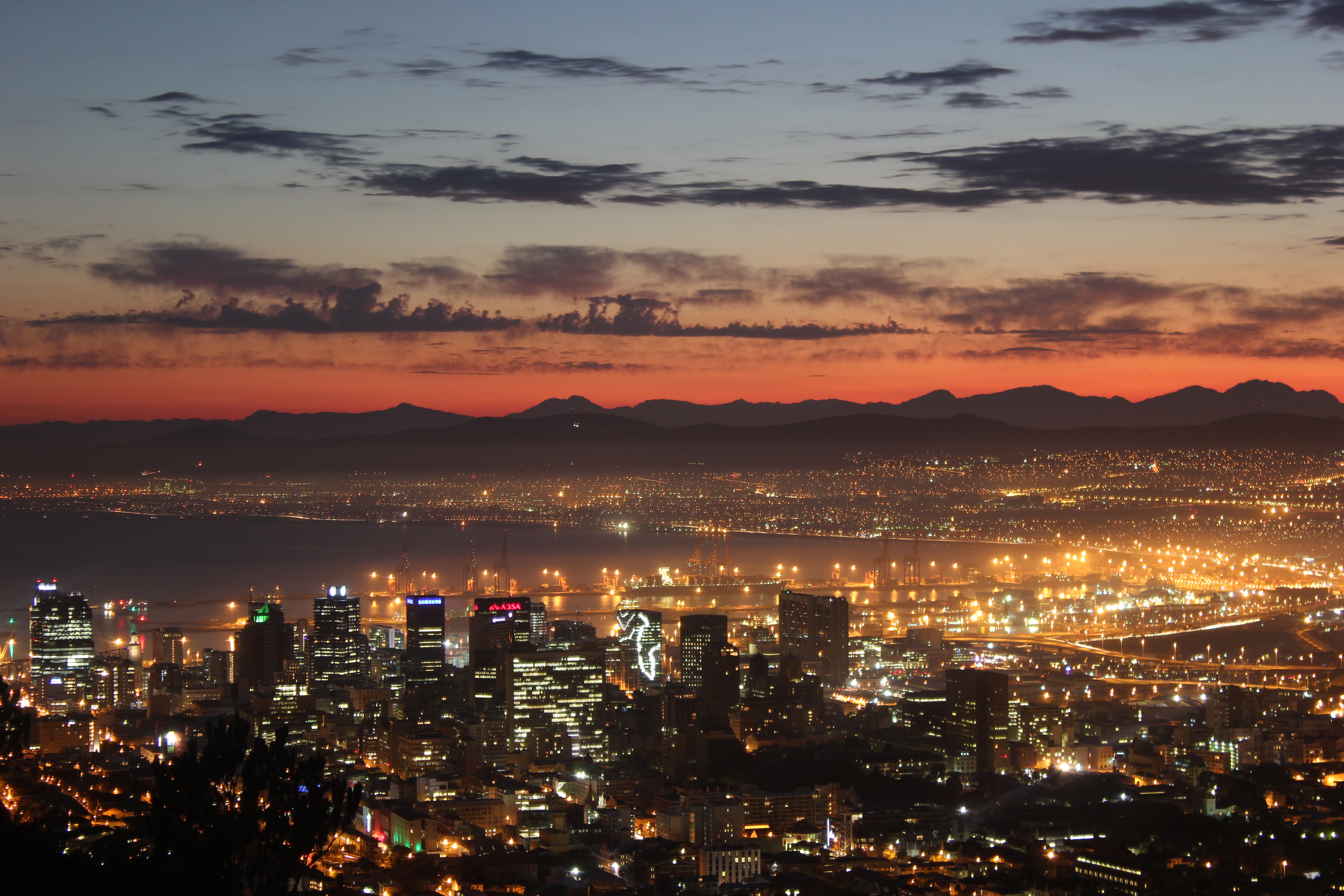Cape Town cityscape at sunrise with mountains and harbor lights HD Wallpaper
