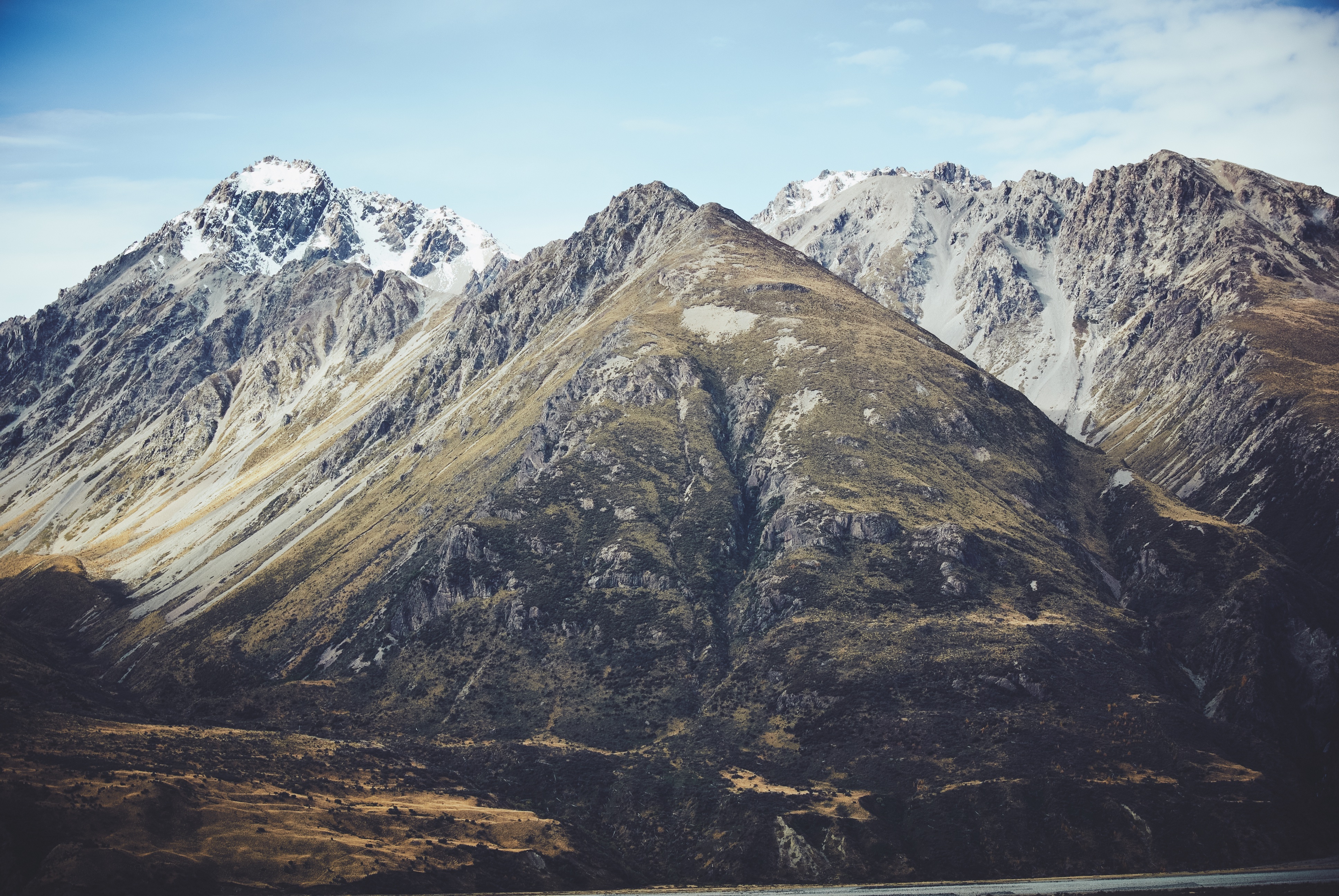 Snow-capped mountains under a blue sky HD Wallpaper
