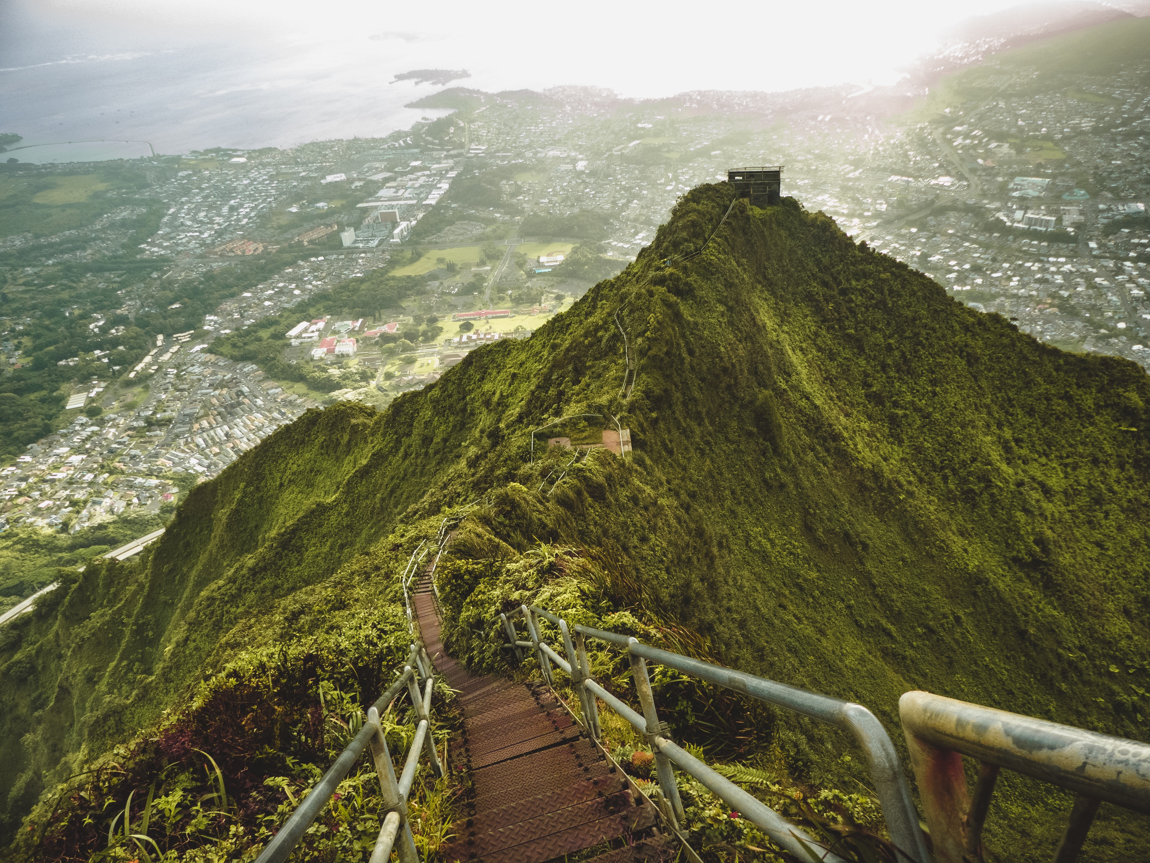 Stairway to Heaven hike on a green mountain overlooking a city HD Wallpaper
