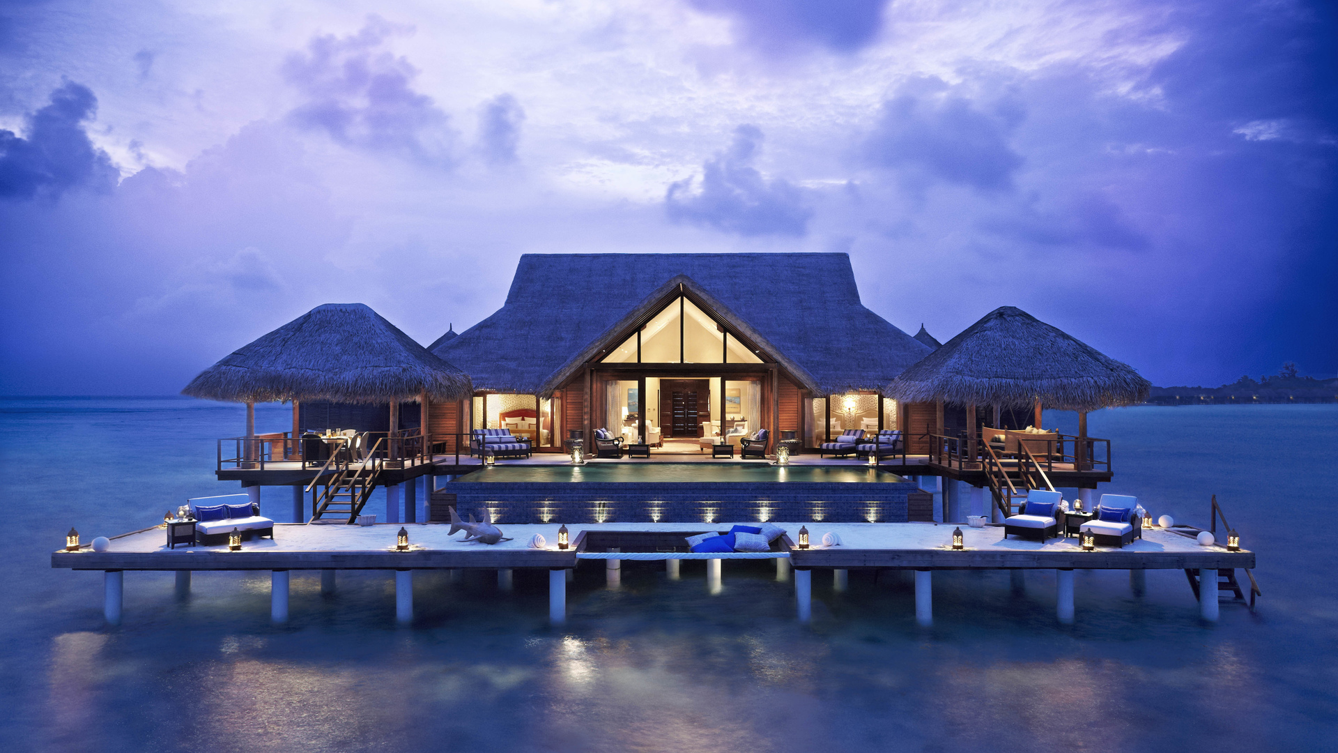 Overwater bungalows with swimming pool at dusk HD Wallpaper