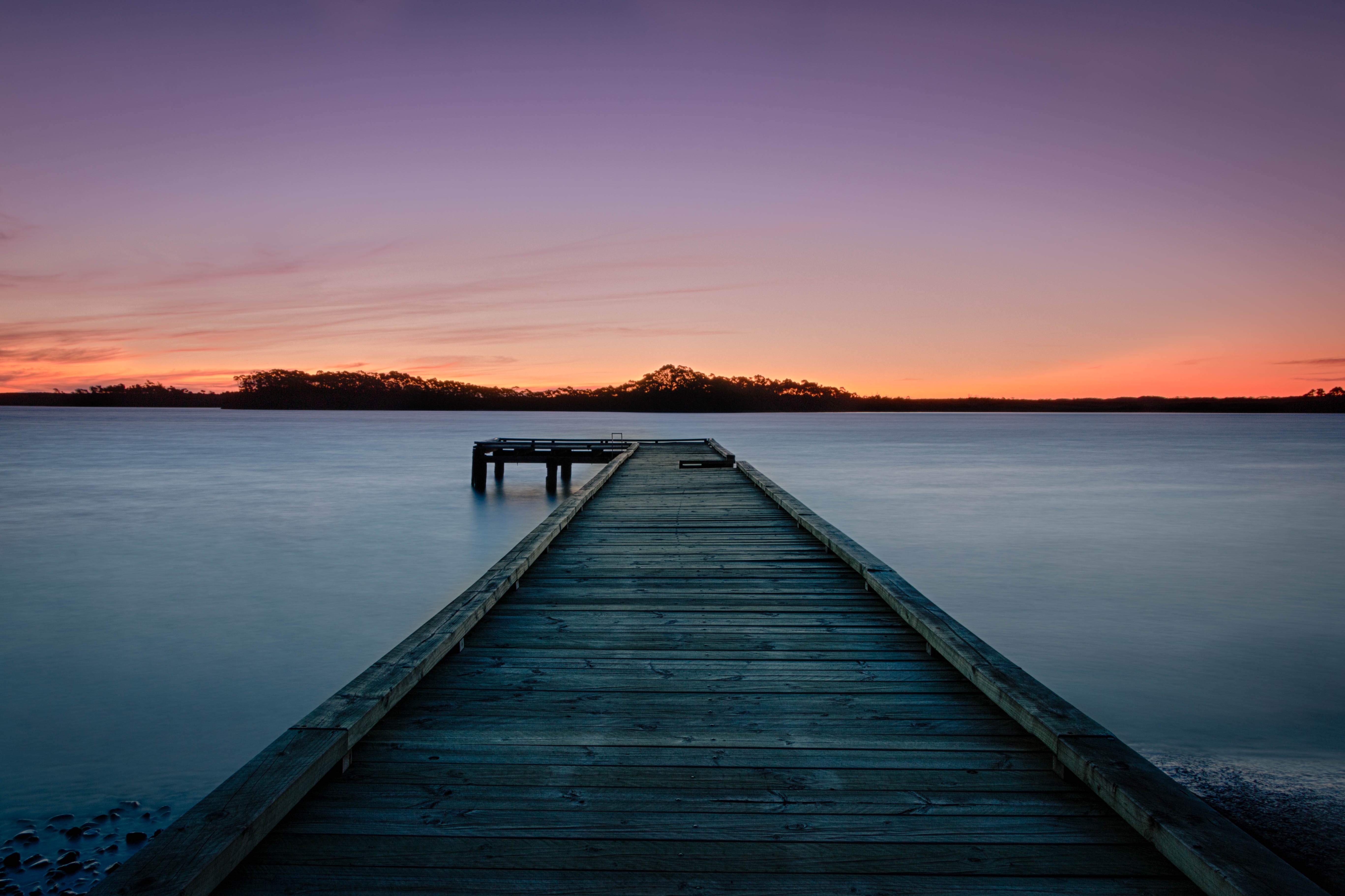 Wooden pier on a calm lake at sunset HD Wallpaper