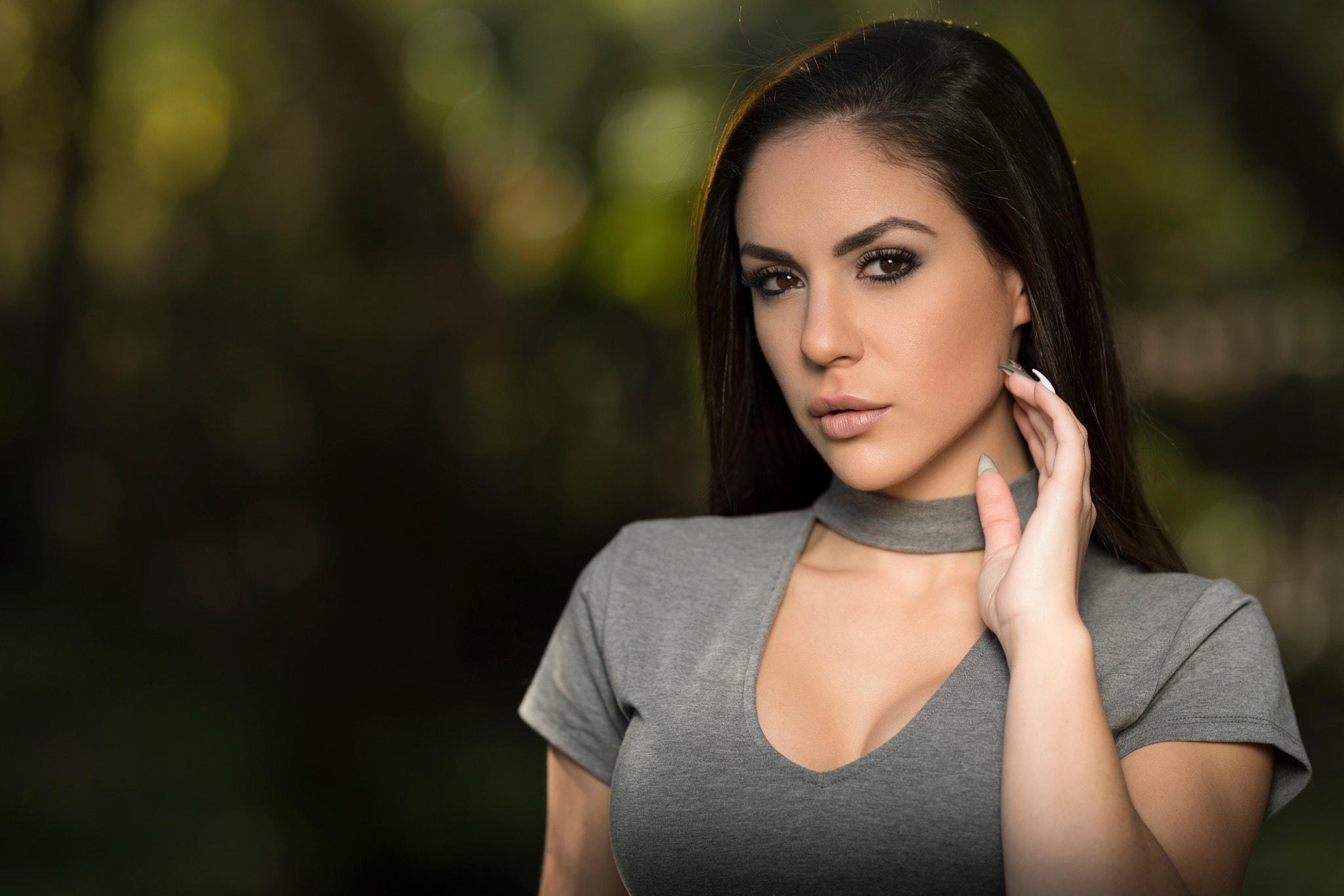 Woman with dark hair in a grey shirt HD Wallpaper