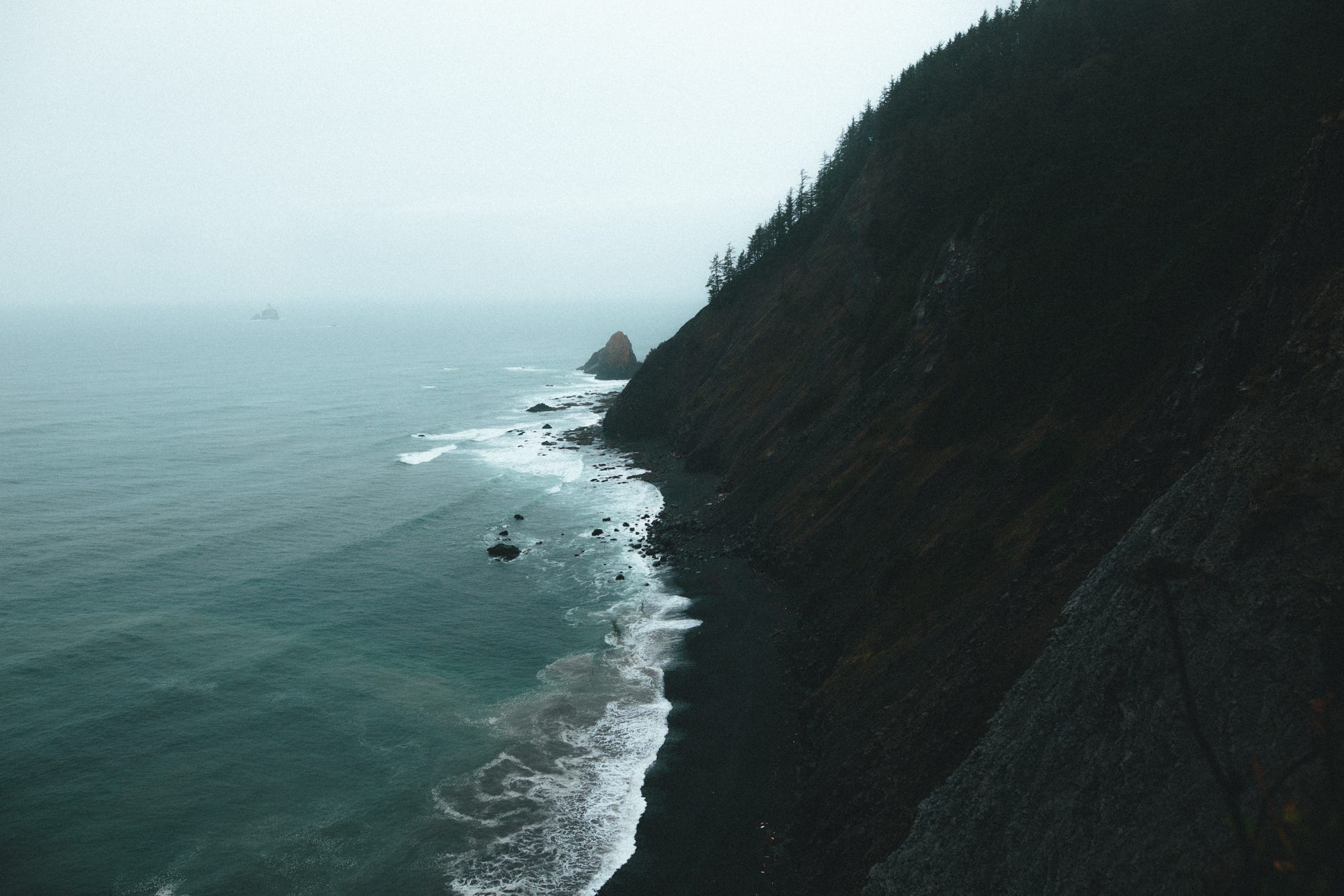 Misty ocean cliffs with waves crashing HD Wallpaper