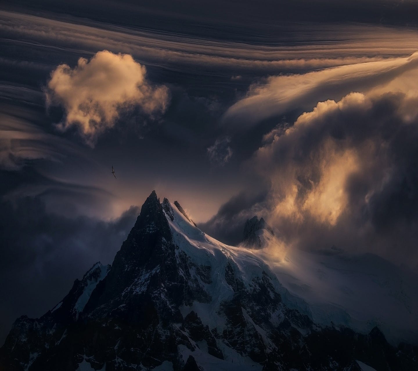 Snowy mountain peak with dramatic clouds and bird HD Wallpaper
