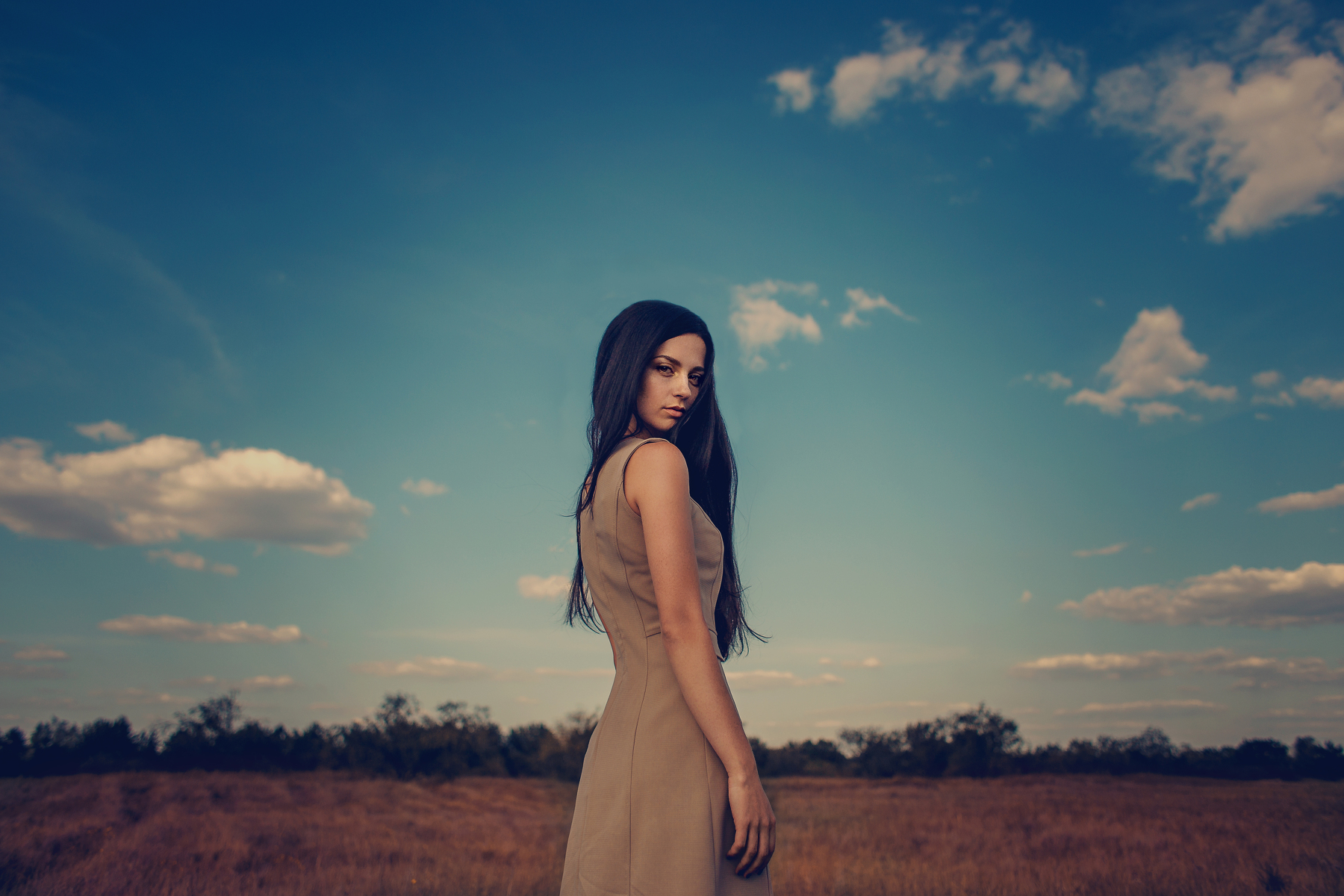 Woman in a dress in a field under the sky HD Wallpaper