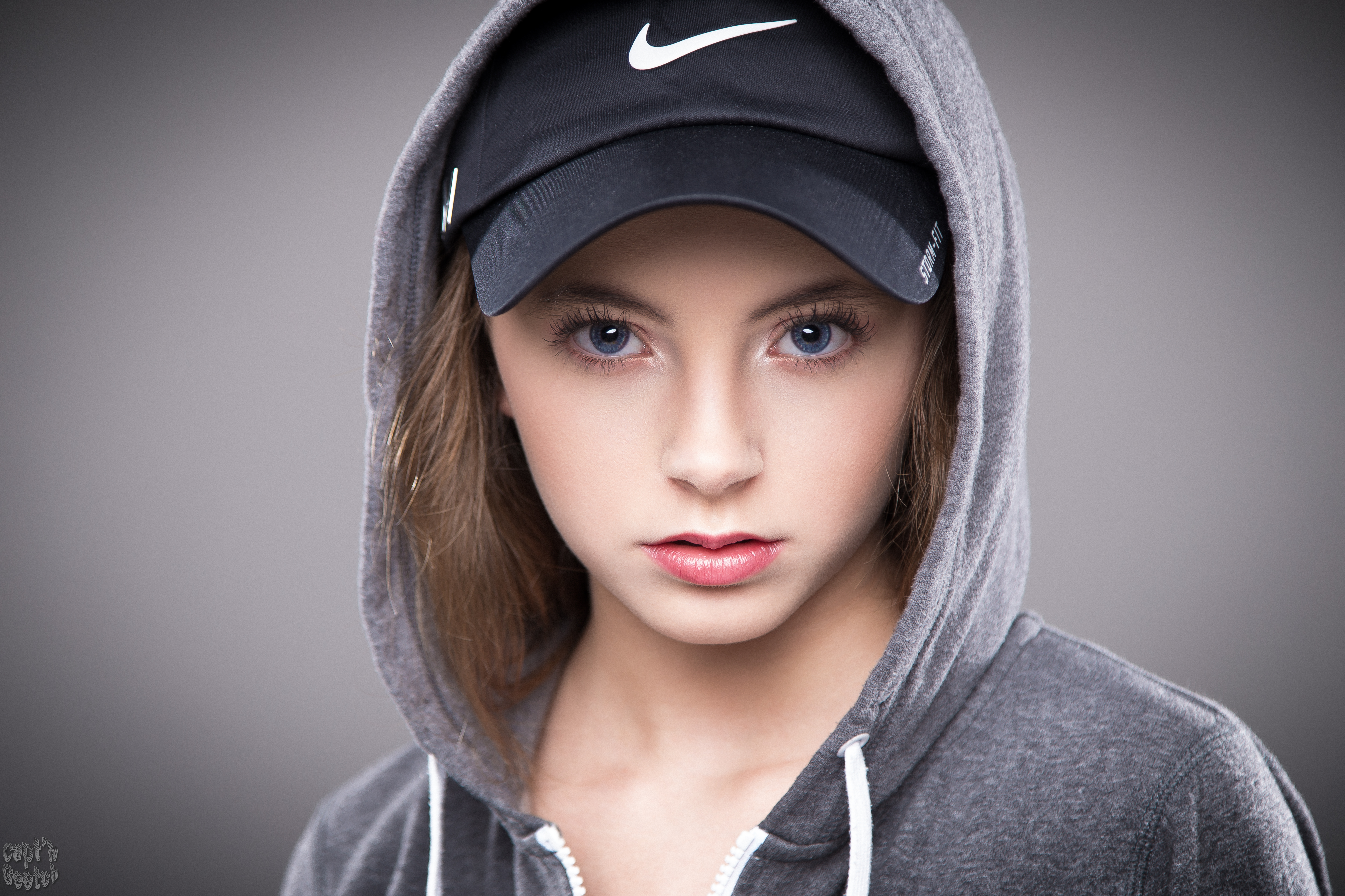 Young woman wearing a Nike baseball cap and hoodie HD Wallpaper