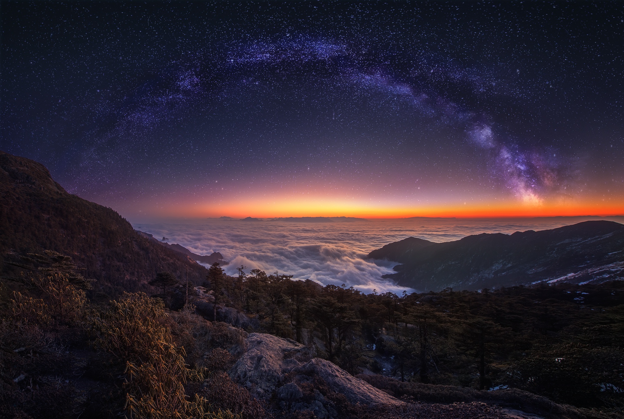 Milky Way over mountains and clouds at dawn HD Wallpaper