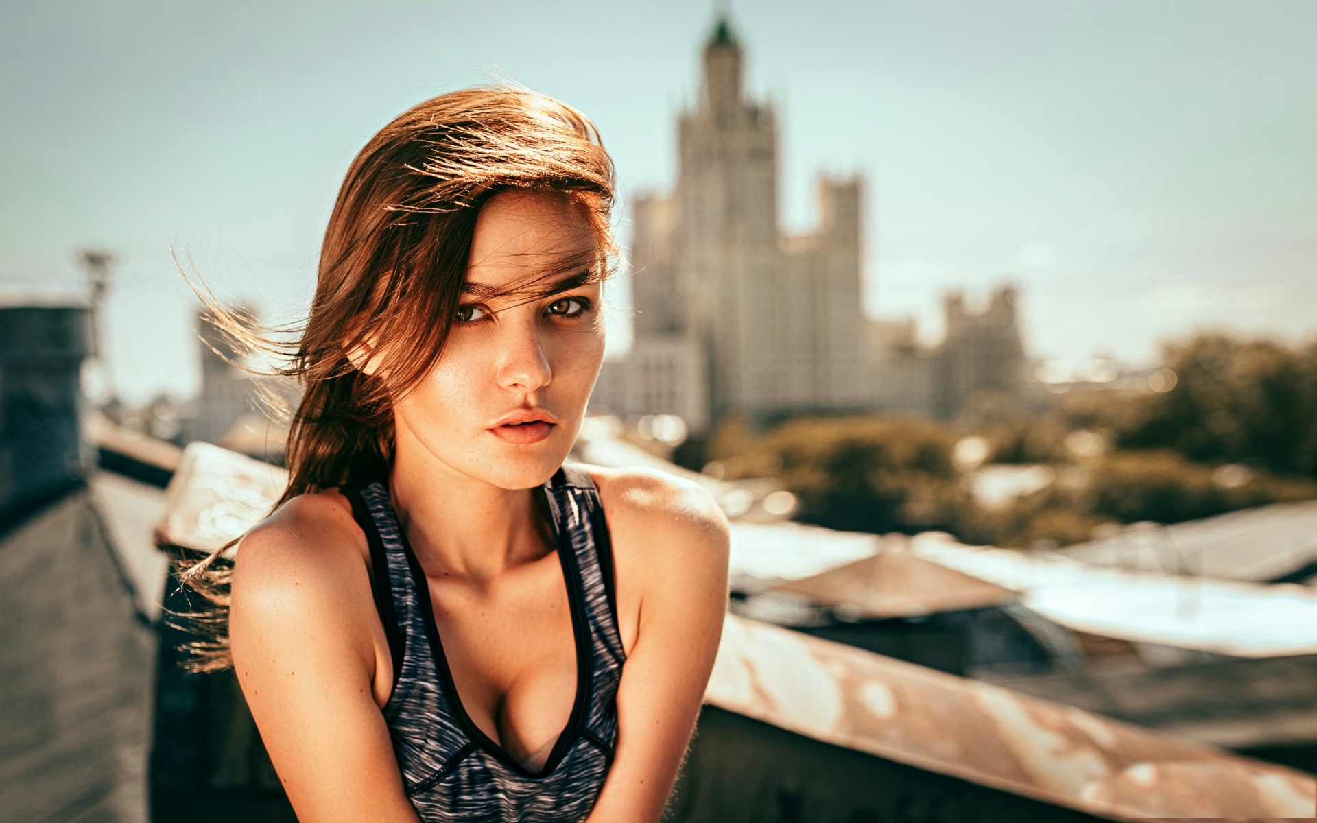 Woman on a rooftop with a building in the background HD Wallpaper