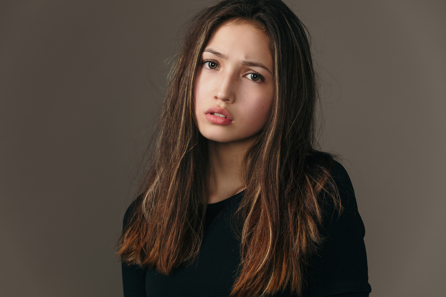 Young woman with long brown hair in a black shirt HD Wallpaper